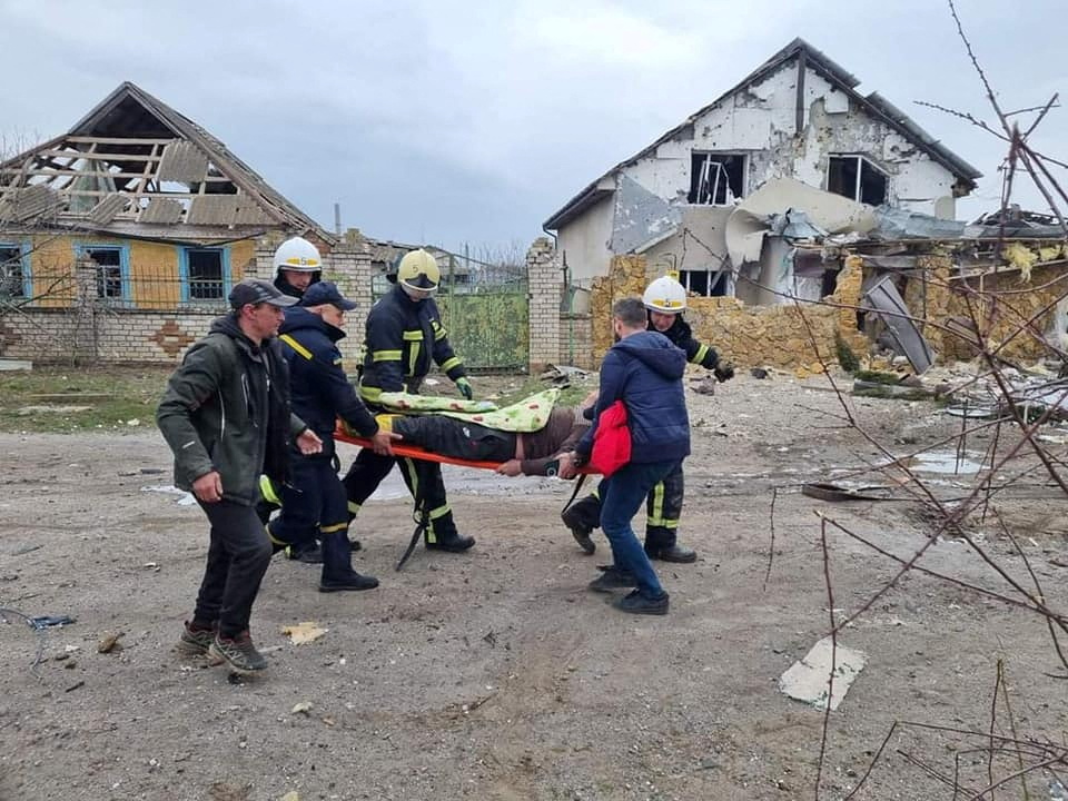 Rescuers carry a civilian injured during shelling in Mykolaiv region