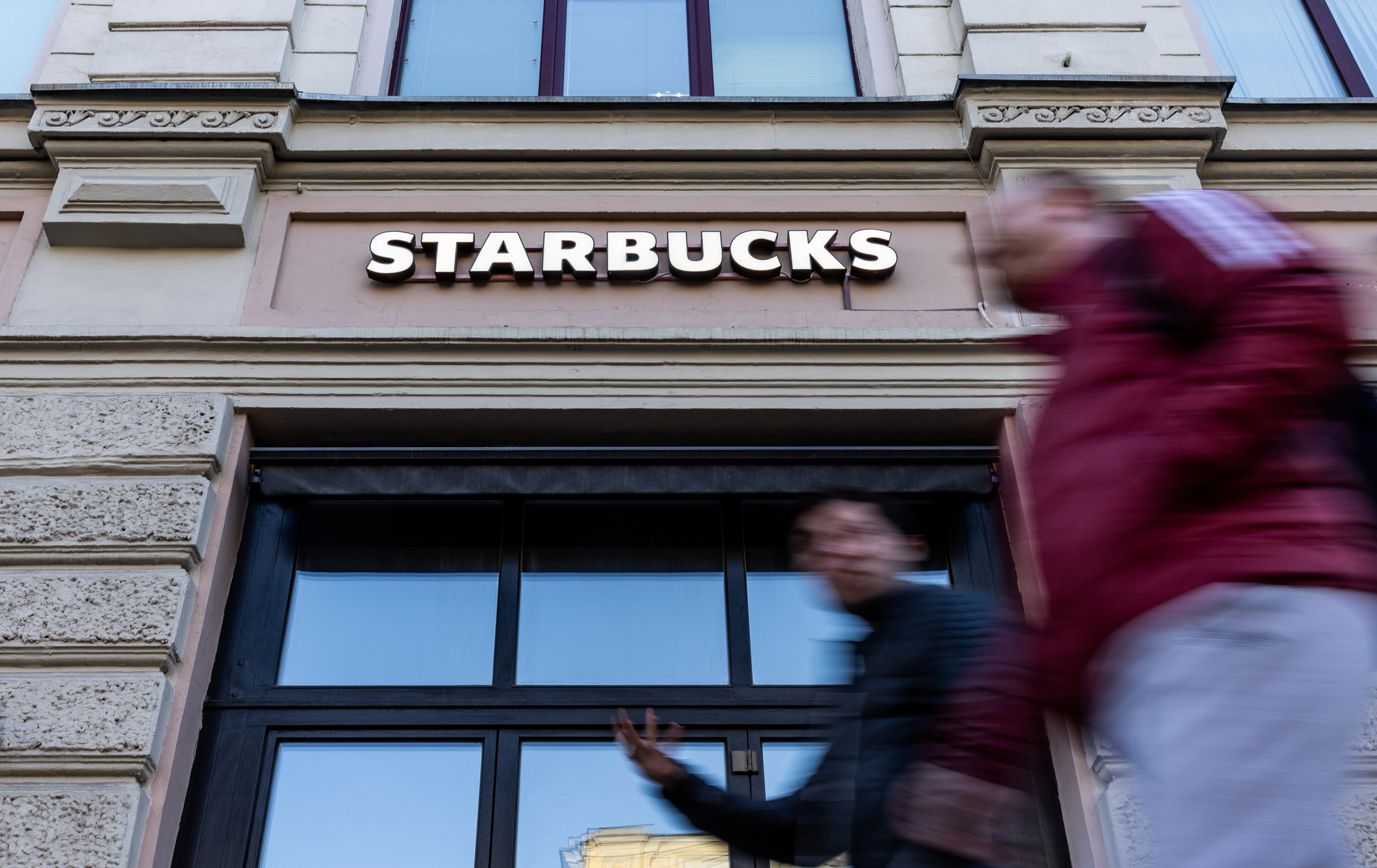 People walk past a closed Starbucks cafe in central Moscow