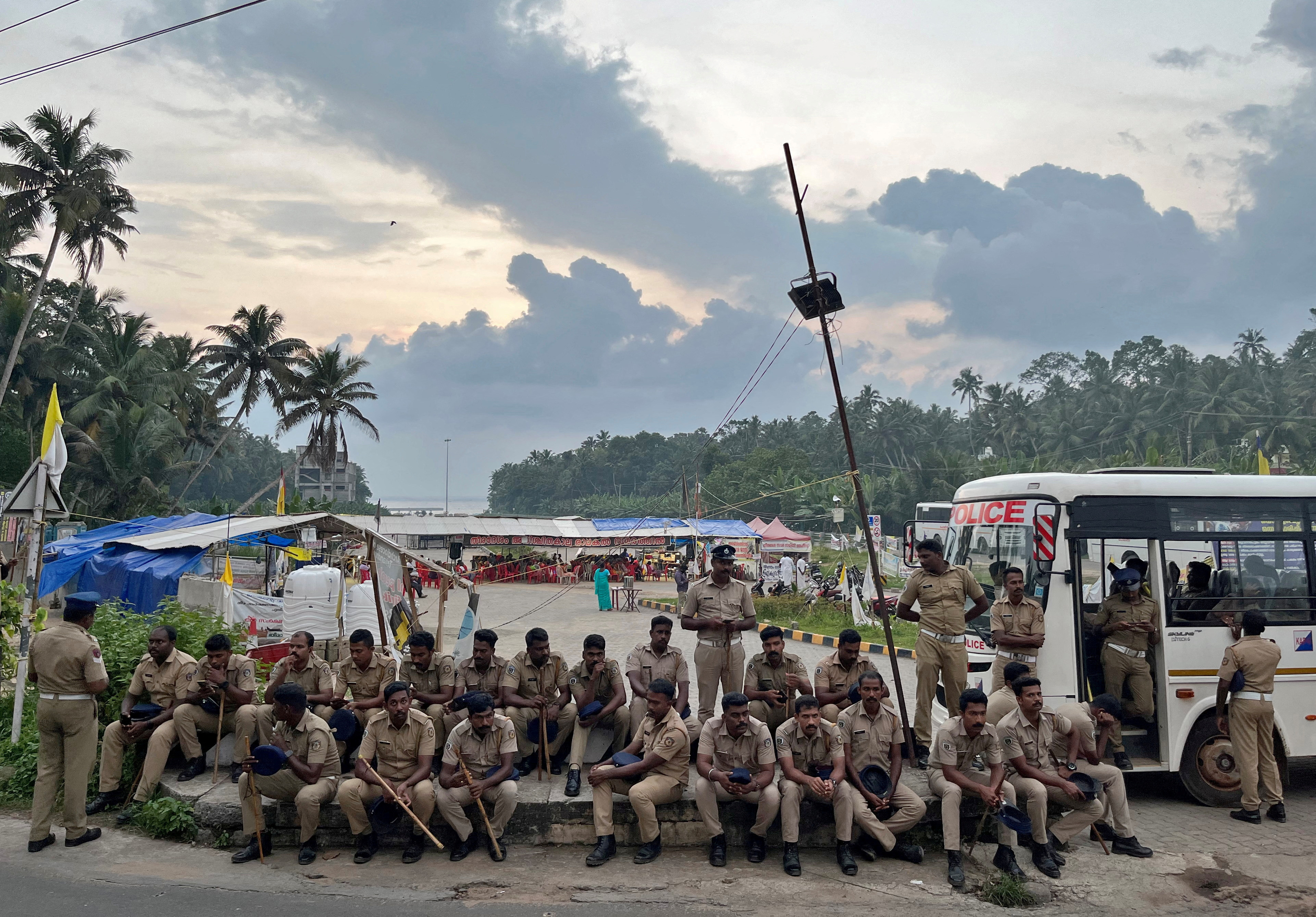 Police officers are deployed as fishermen protest near the entrance of the proposed Vizhinjam Port