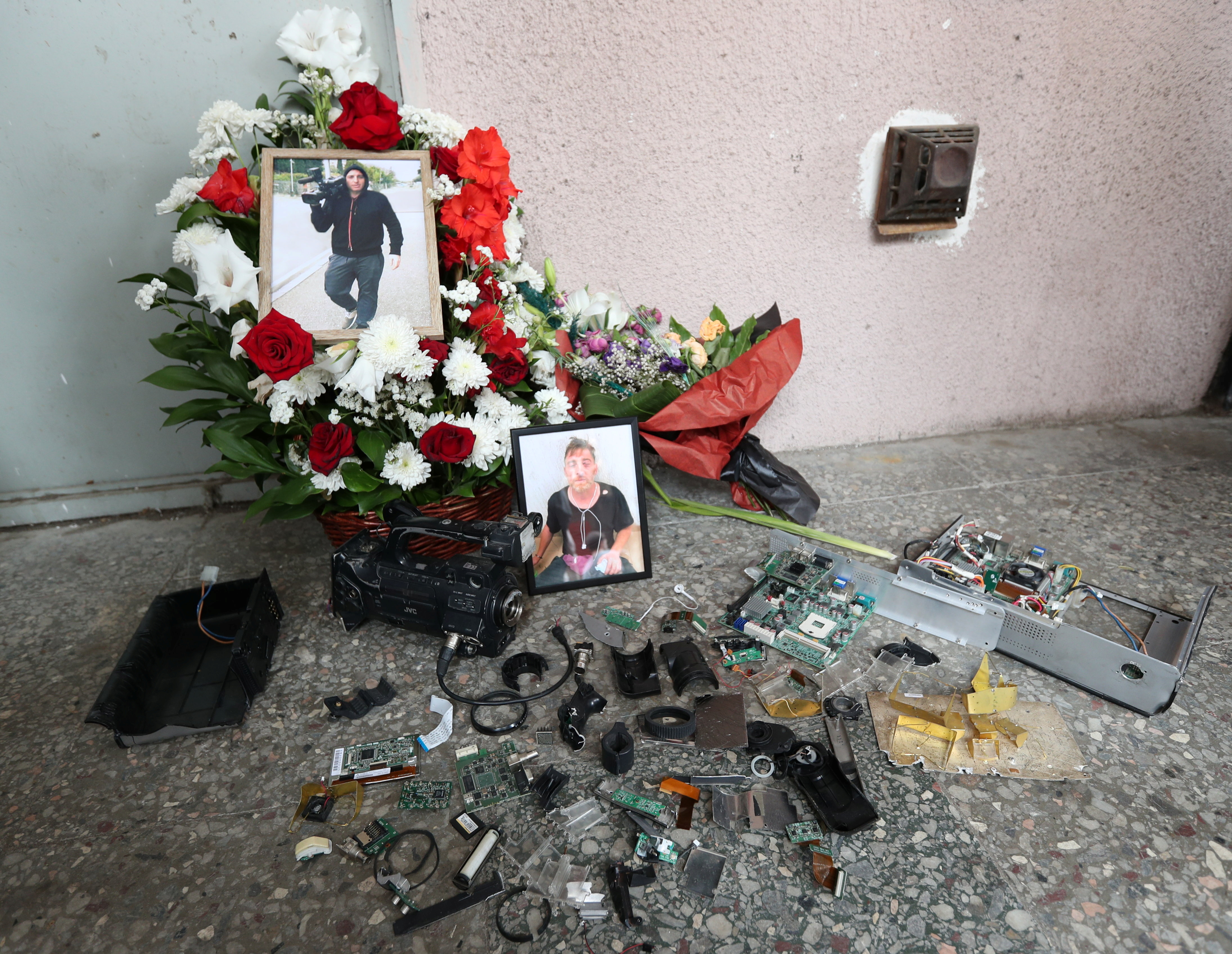 Scuffles flare in Georgia parliament after death of journalist 7 Portraits of journalist Alexander Lashkarava are placed next to a broken camera during his funeral in Tbilisi, Georgia July 13, 2021. Lashkarava was found dead at his home several days after he was beaten during attacks on LGBT+ activists in Tbilisi. REUTERS/Irakli Gedenidze