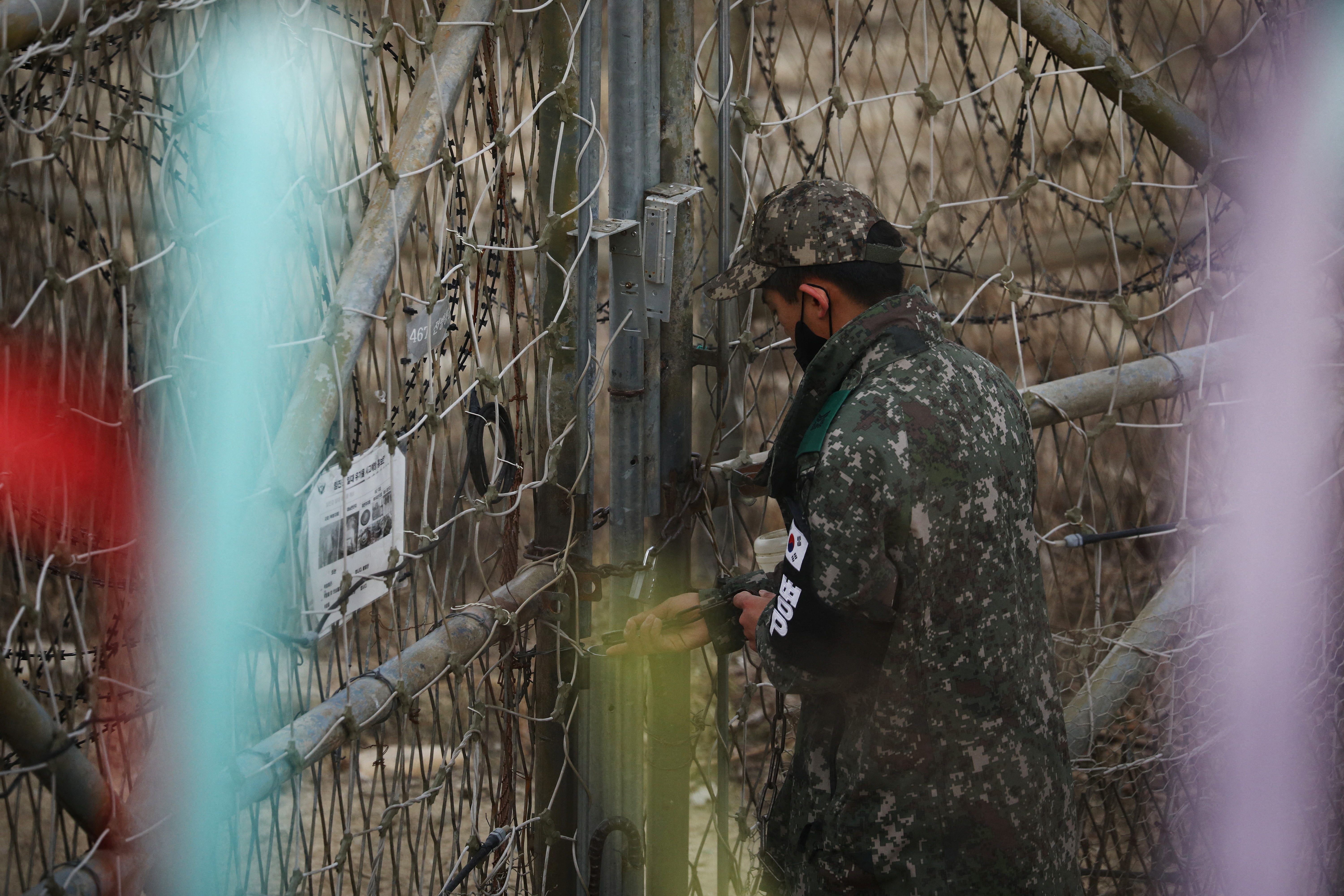 A South Korean soldier locks an entrance to a guard post near the demilitarised zone which separates the two Koreas in Paju