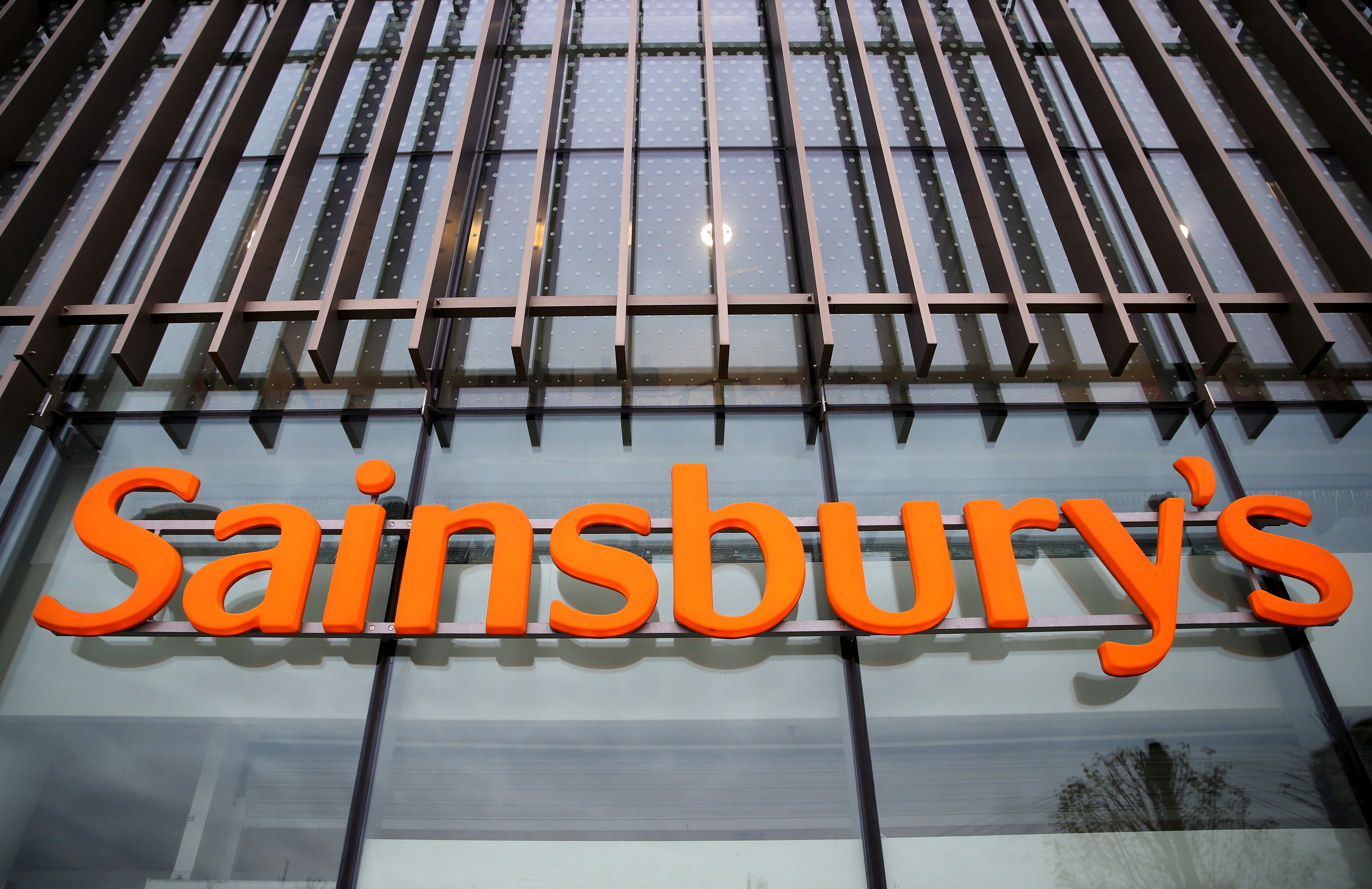 File photograph of a sign displayed outside a Sainsbury's store in London