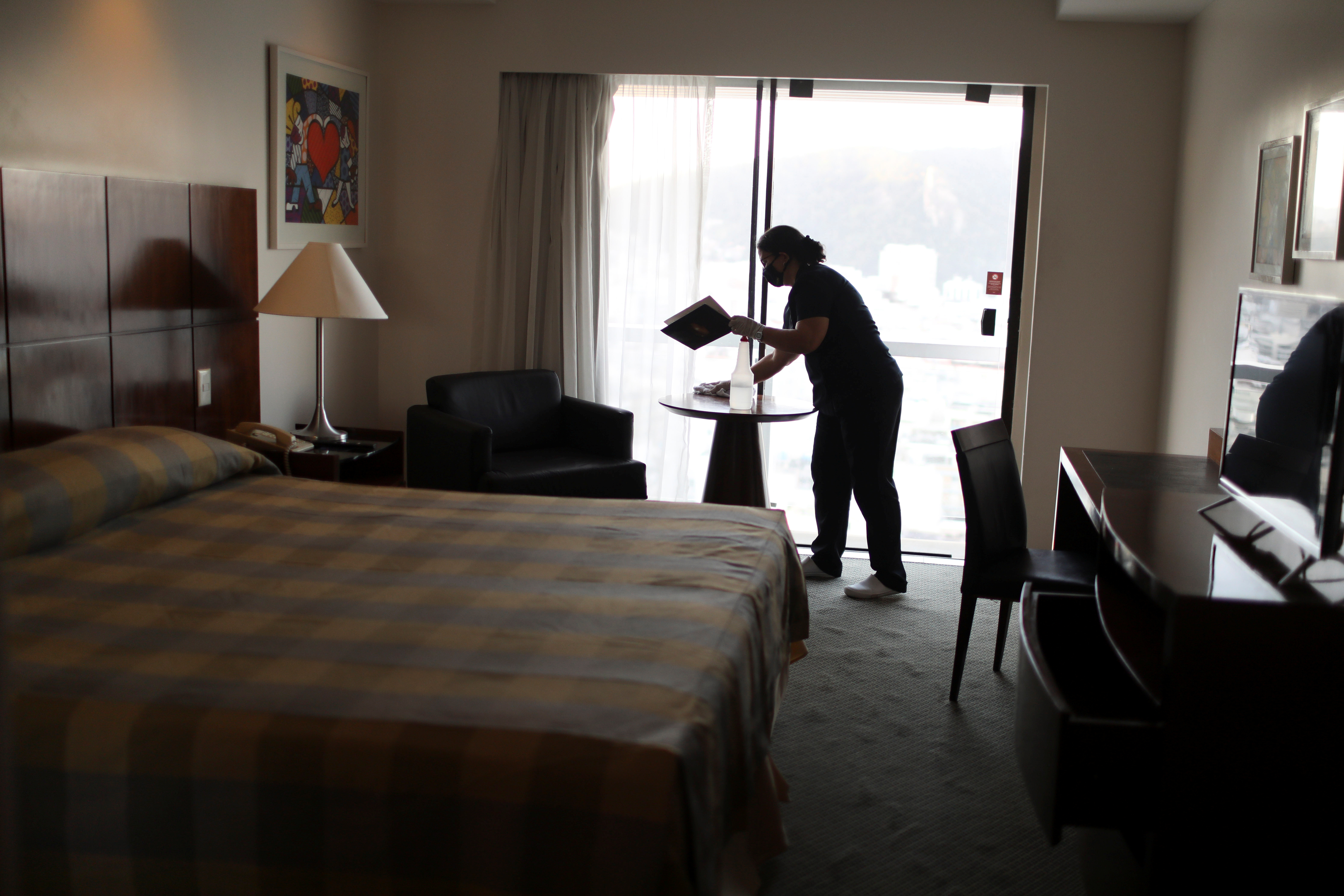 A hotel worker cleans a room in a hotel in Rio de Janeiro