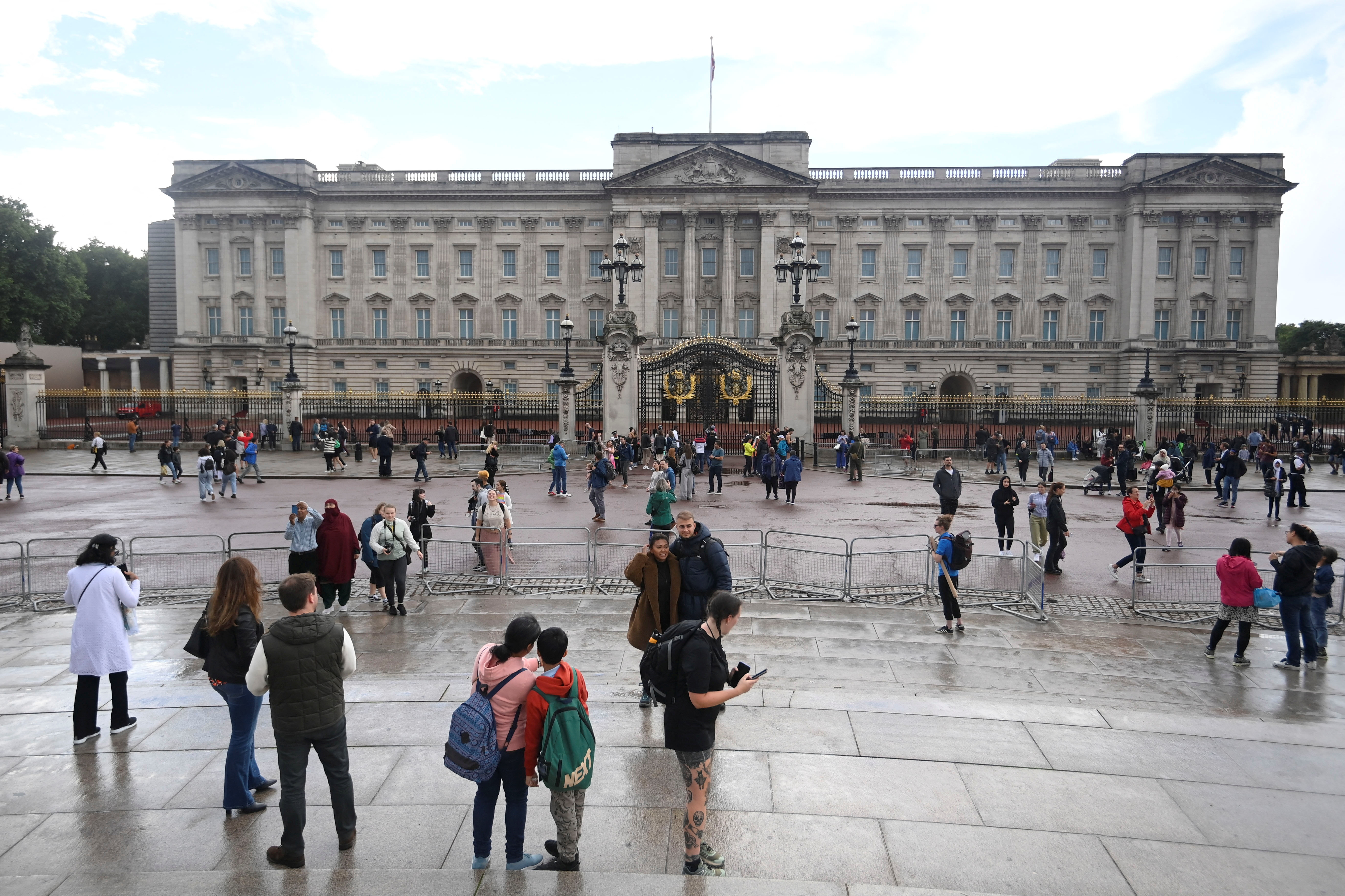 People gather outside Buckingham Palace in London