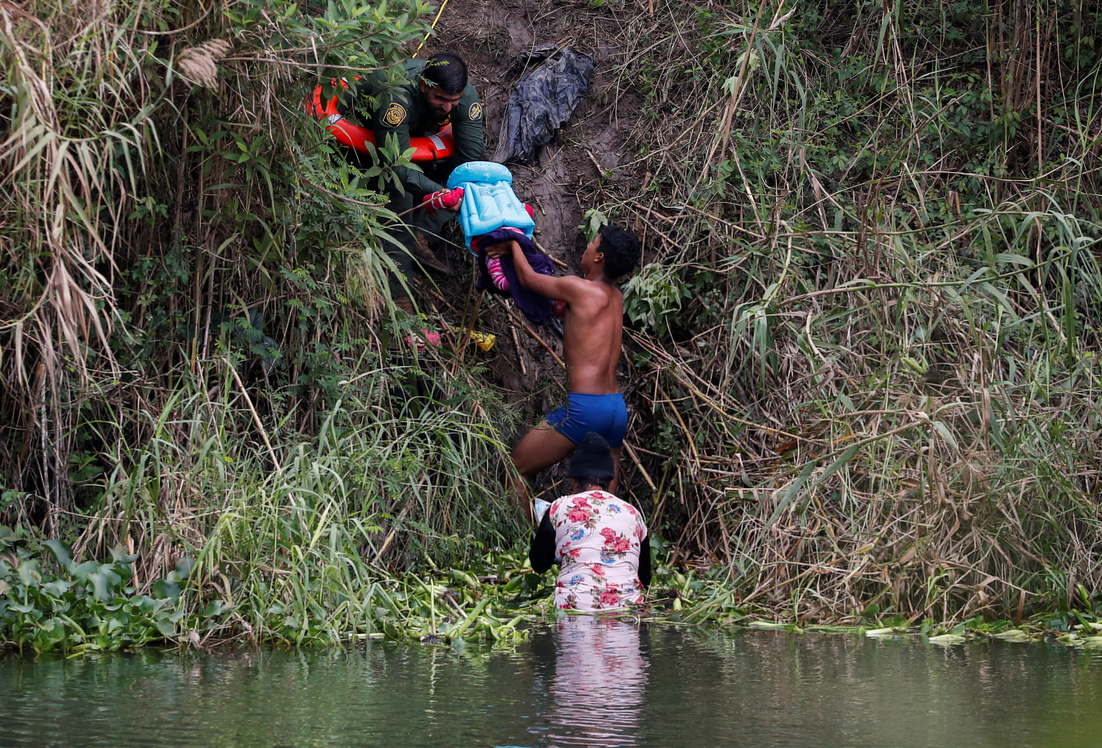 Migrants seeking asylum in the United States cross the Rio Bravo river, in Matamoros
