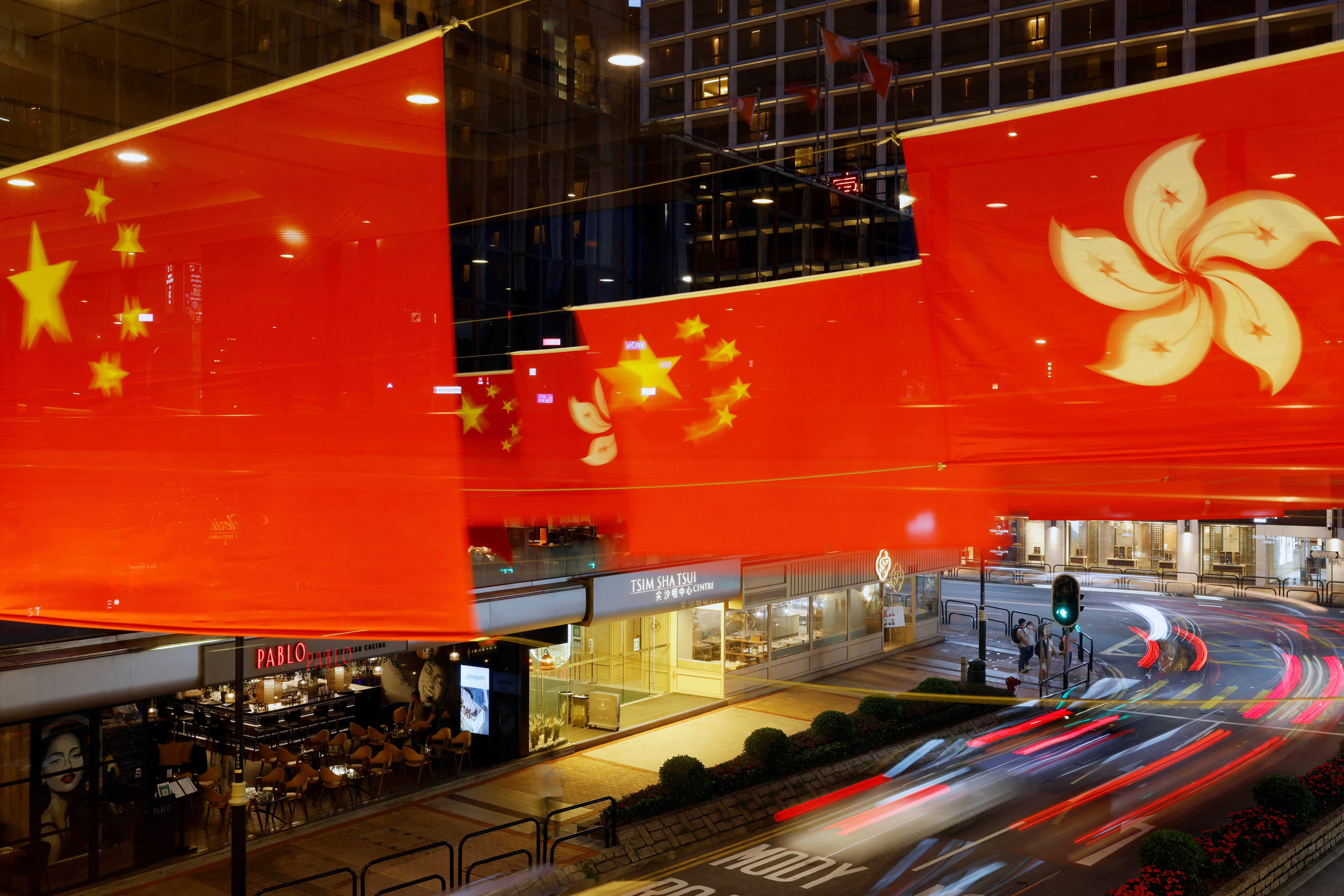 Rows of Chinese and Hong Kong flags decorate a street outside a shopping mall in Hong Kong