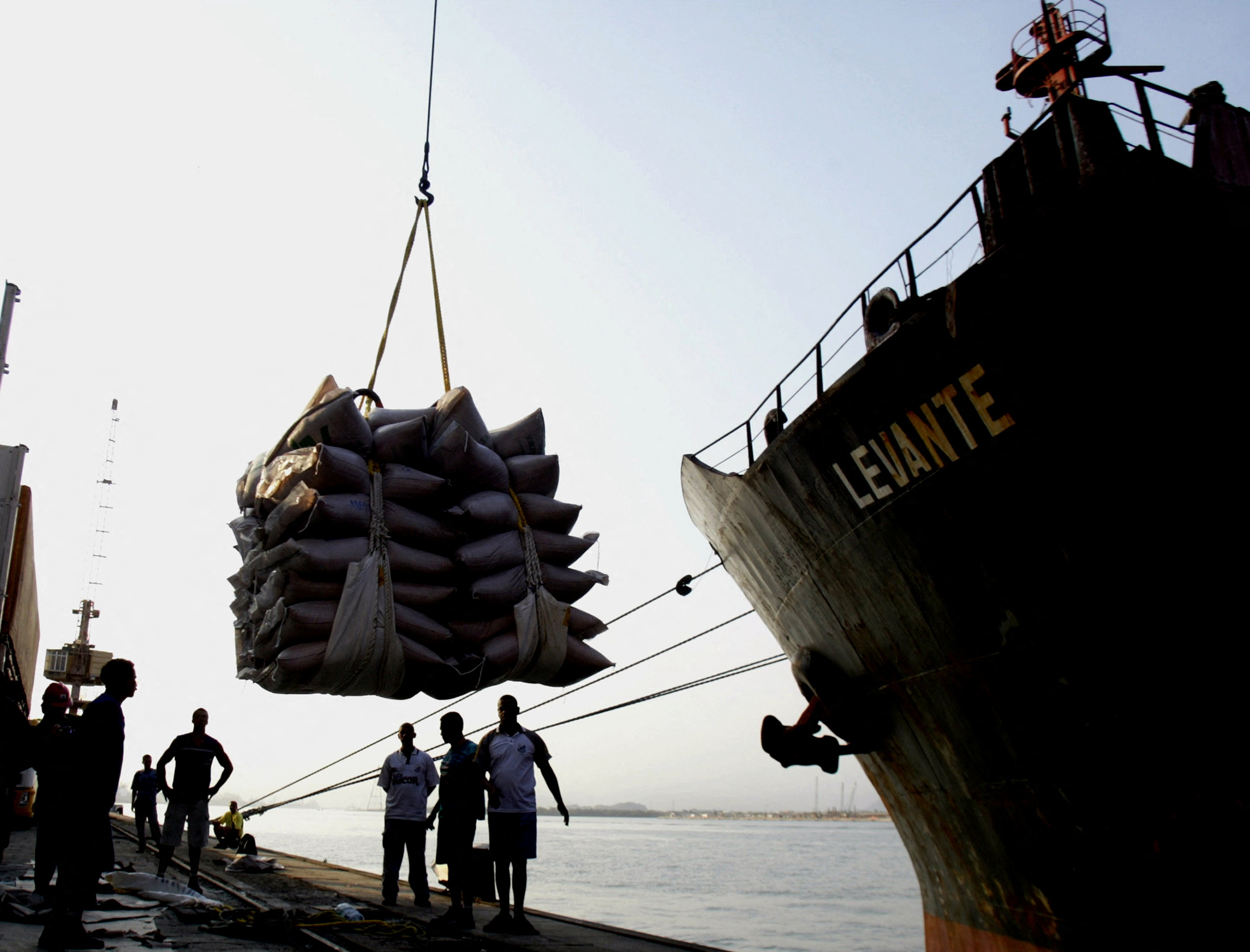 A ship is loaded with sugar sacks on the docks at port of Santos.