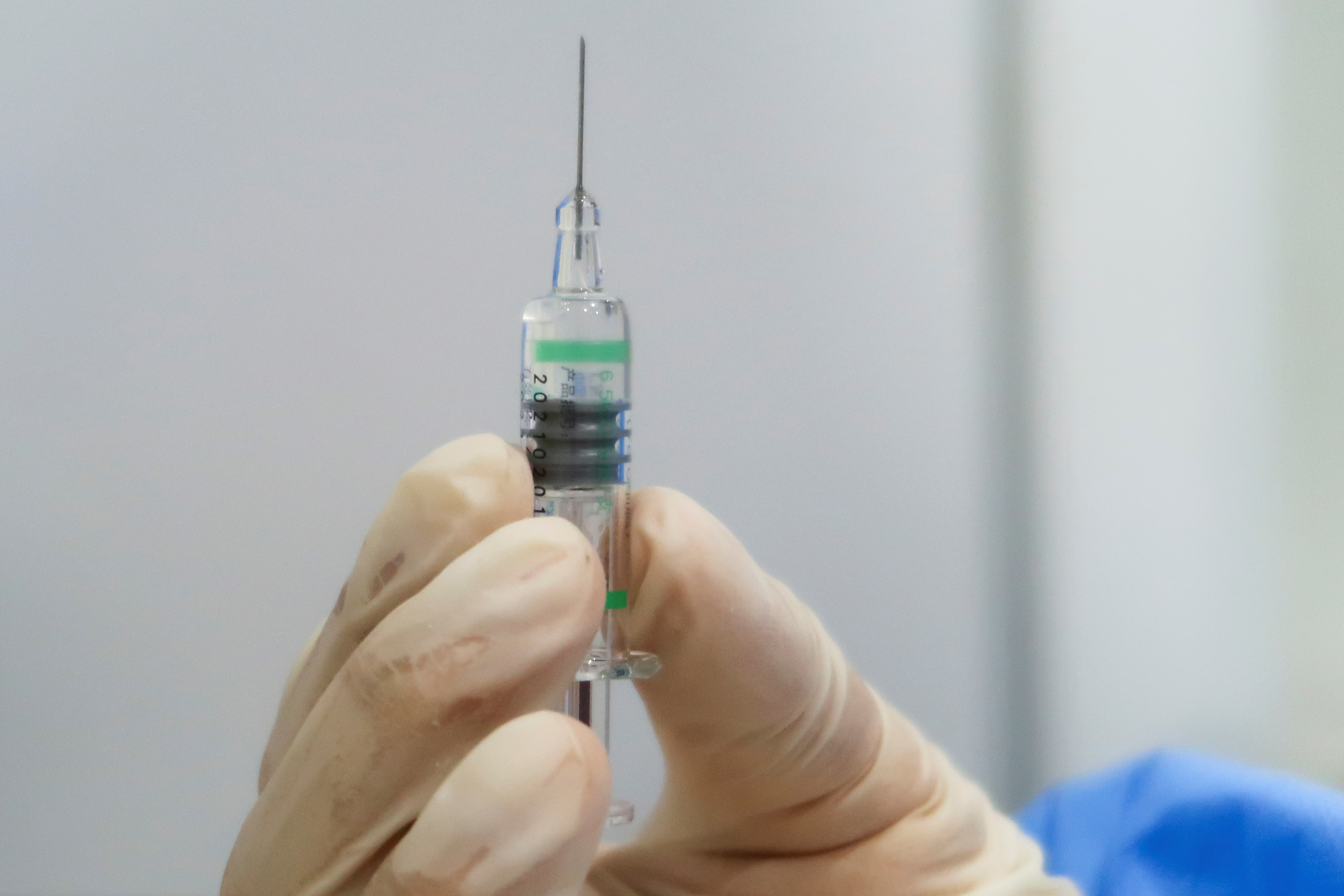 A nurse holds a syringe containing a coronavirus disease (COVID-19) vaccine by Sinopharm at a vaccination center in Beijing