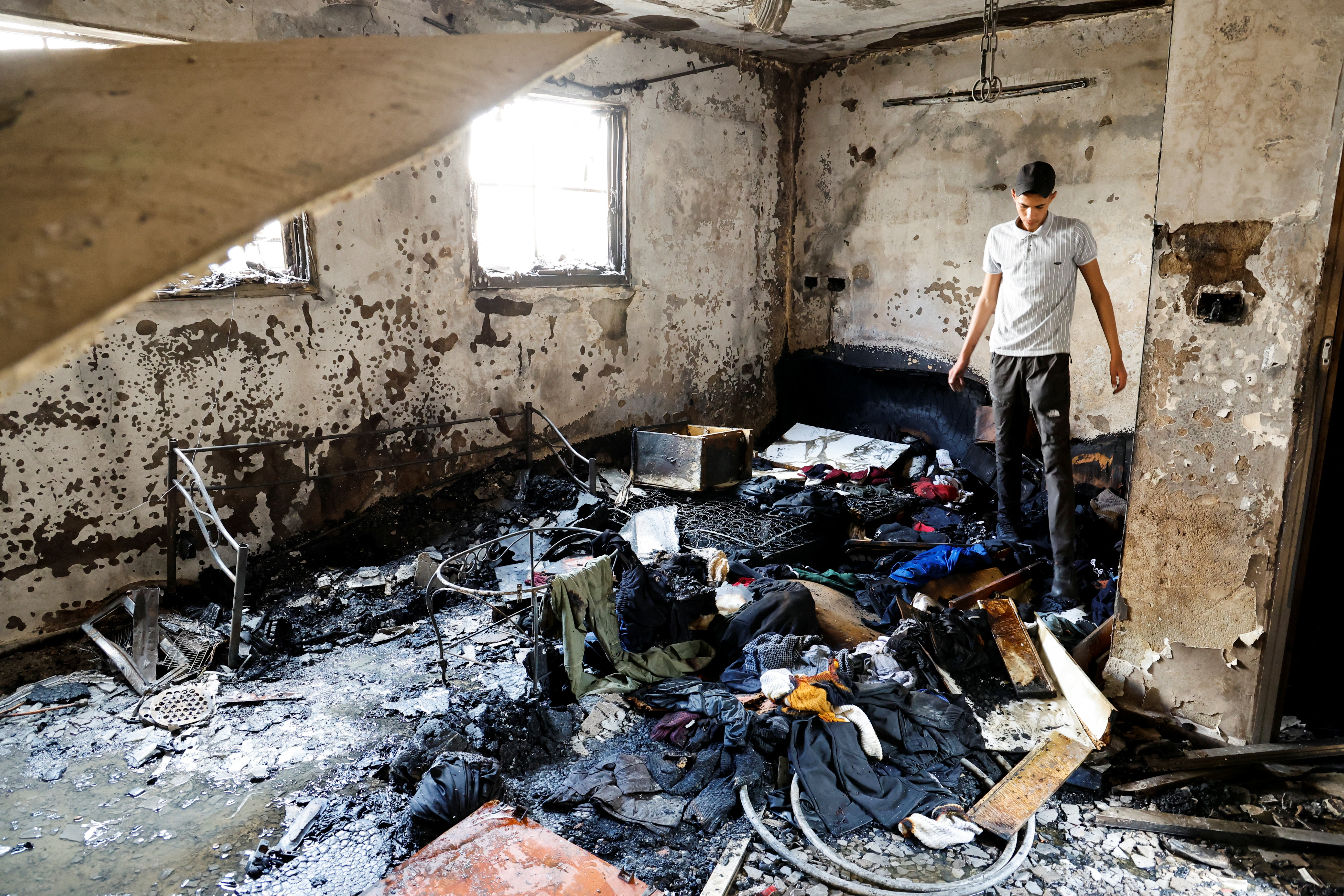A man stands in a damaged building at the site of a deadly Israeli attack in the Balata camp.