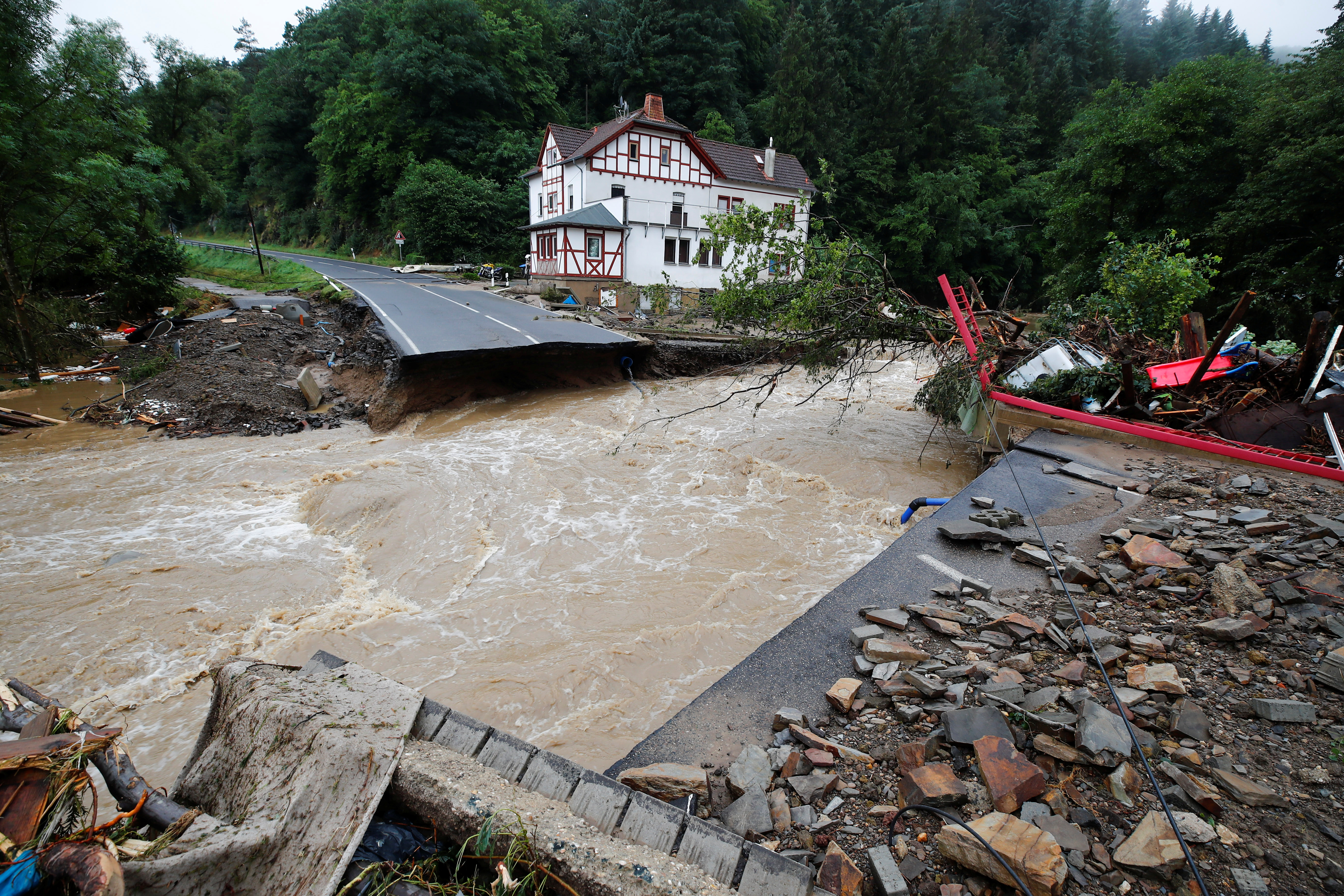 A destroyed road next to the Ahr river is seen on a flood-affected area following heavy rainfalls in Schuld, Germany, on July 15, 2021. REUTERS/Wolfgang Rattay