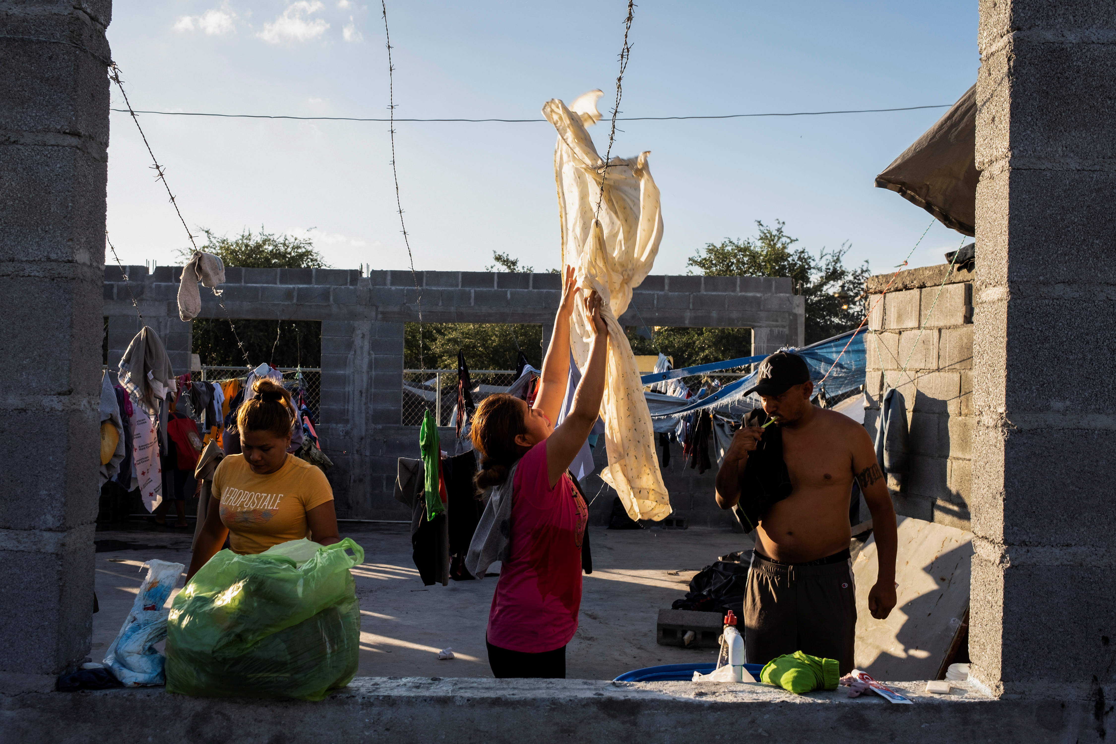 Asylum-seeking migrants live in a public square in Reynosa