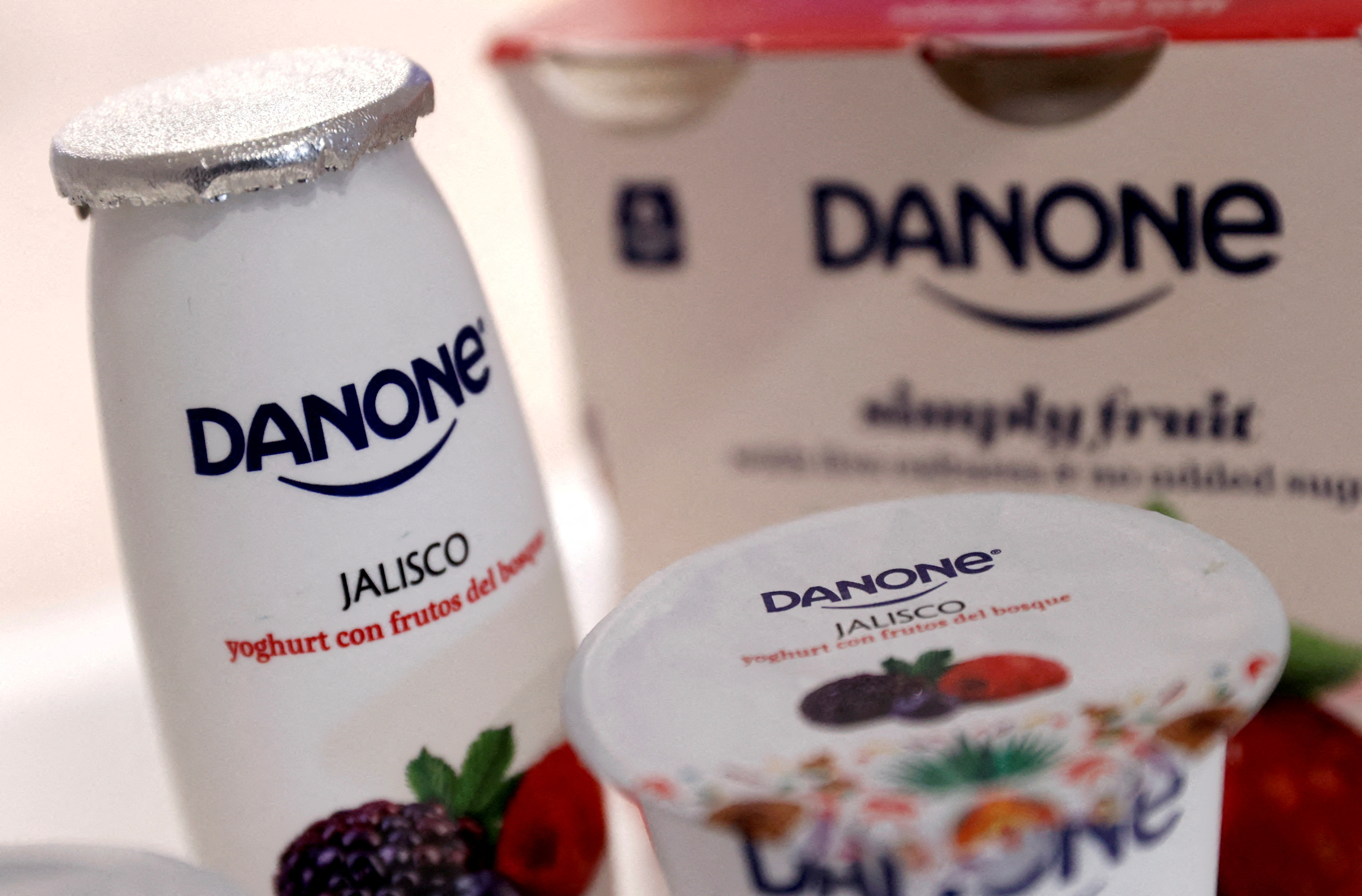 Company logos are seen on products displayed before French food group Danone 2019 annual results presentation in Paris