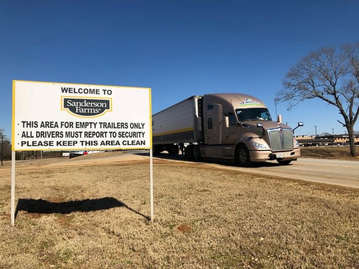 A truck laden with chicken leg quarters leaves Sanderson Farms poultry processing plant enroute to Mexico, in Palestine