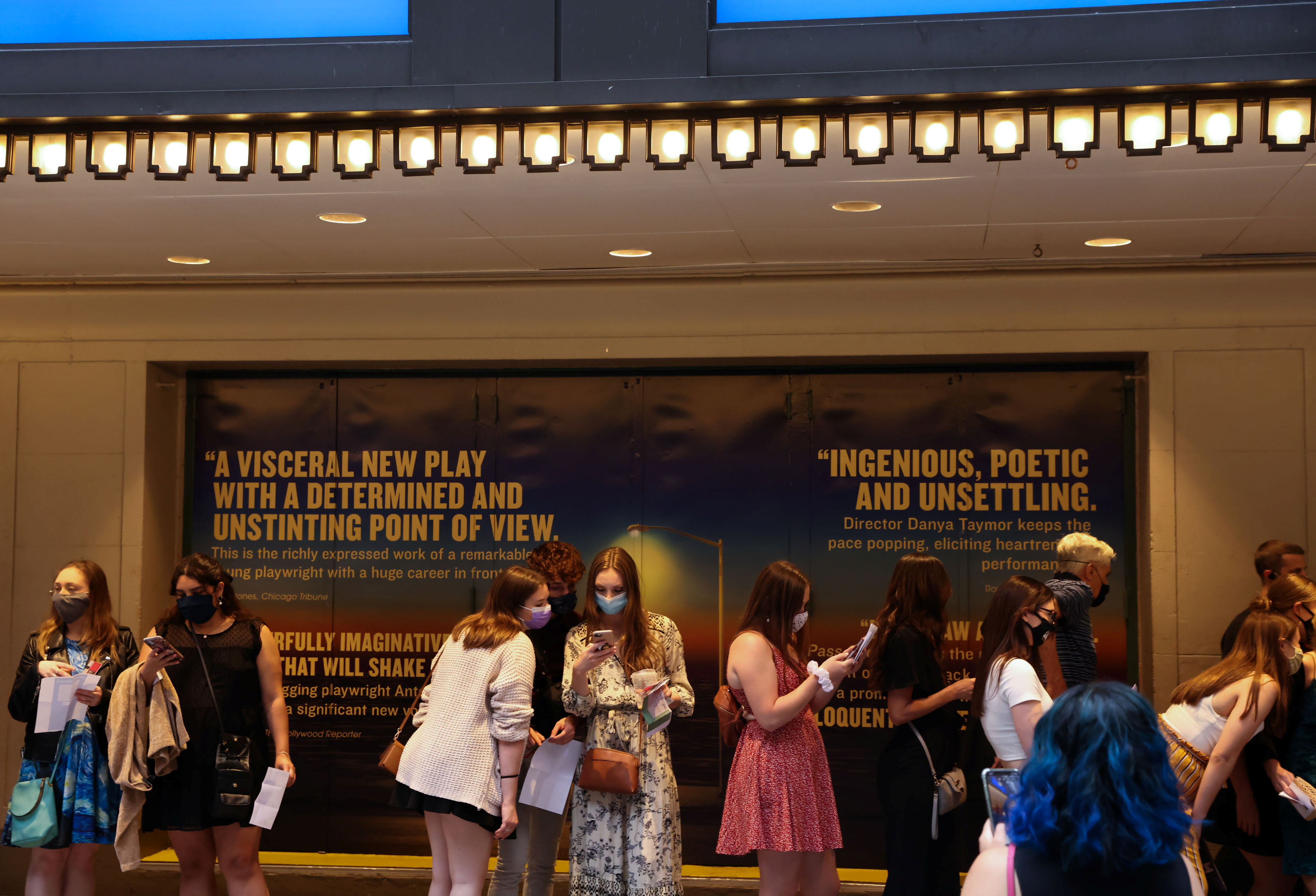 Guests wait in line to attend the opening night of previews for 