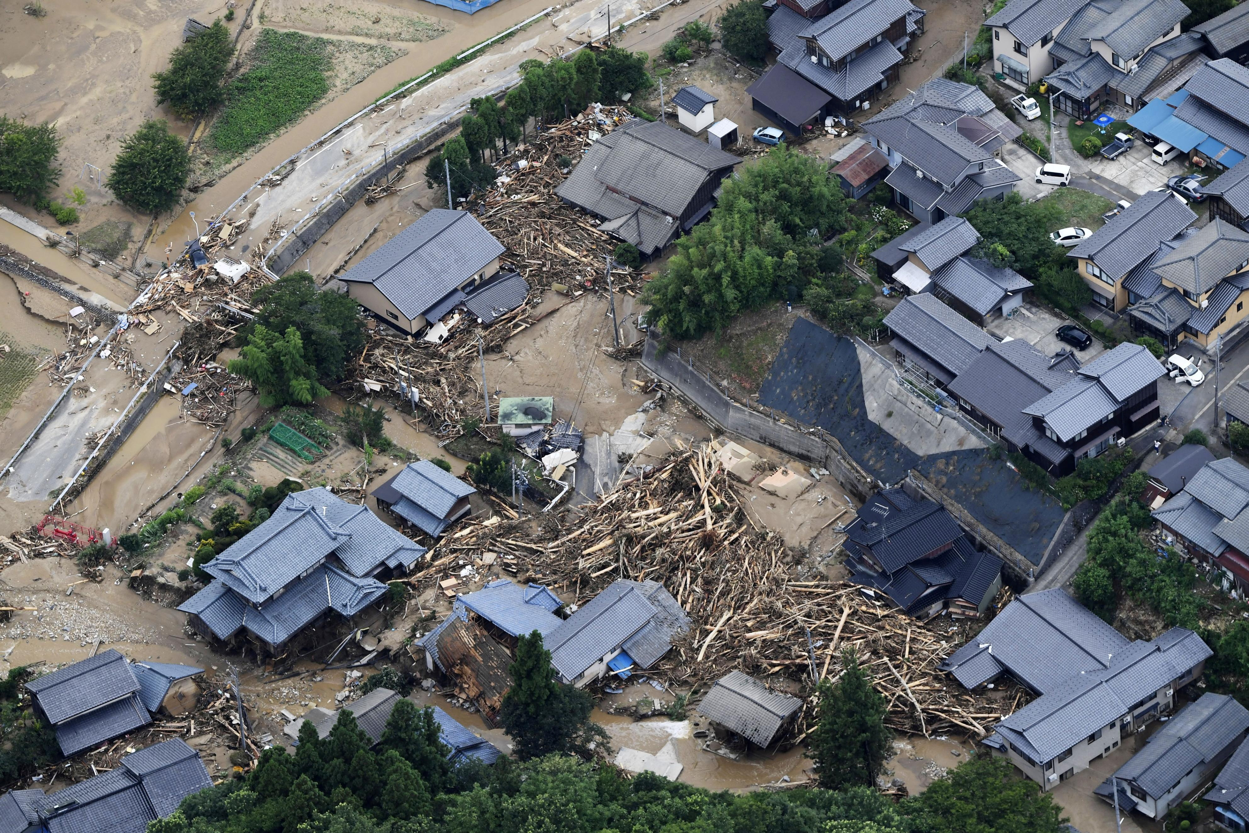 An aerial view shows debris and destroyed houses, caused by a flash flood due to heavy rains, in Murakami, Niigata prefecture