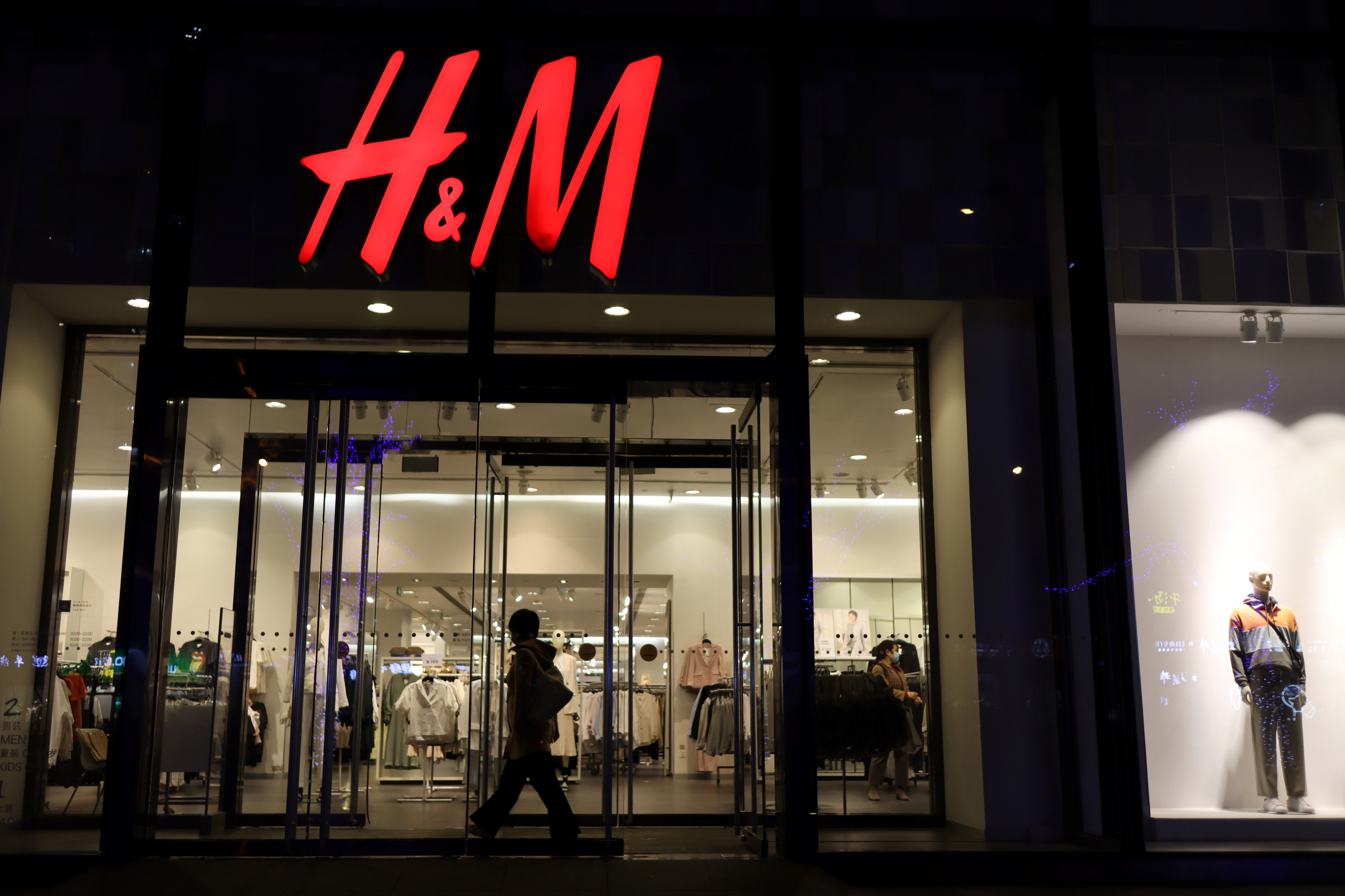 Woman enters an H&M store at a shopping mall in Beijing