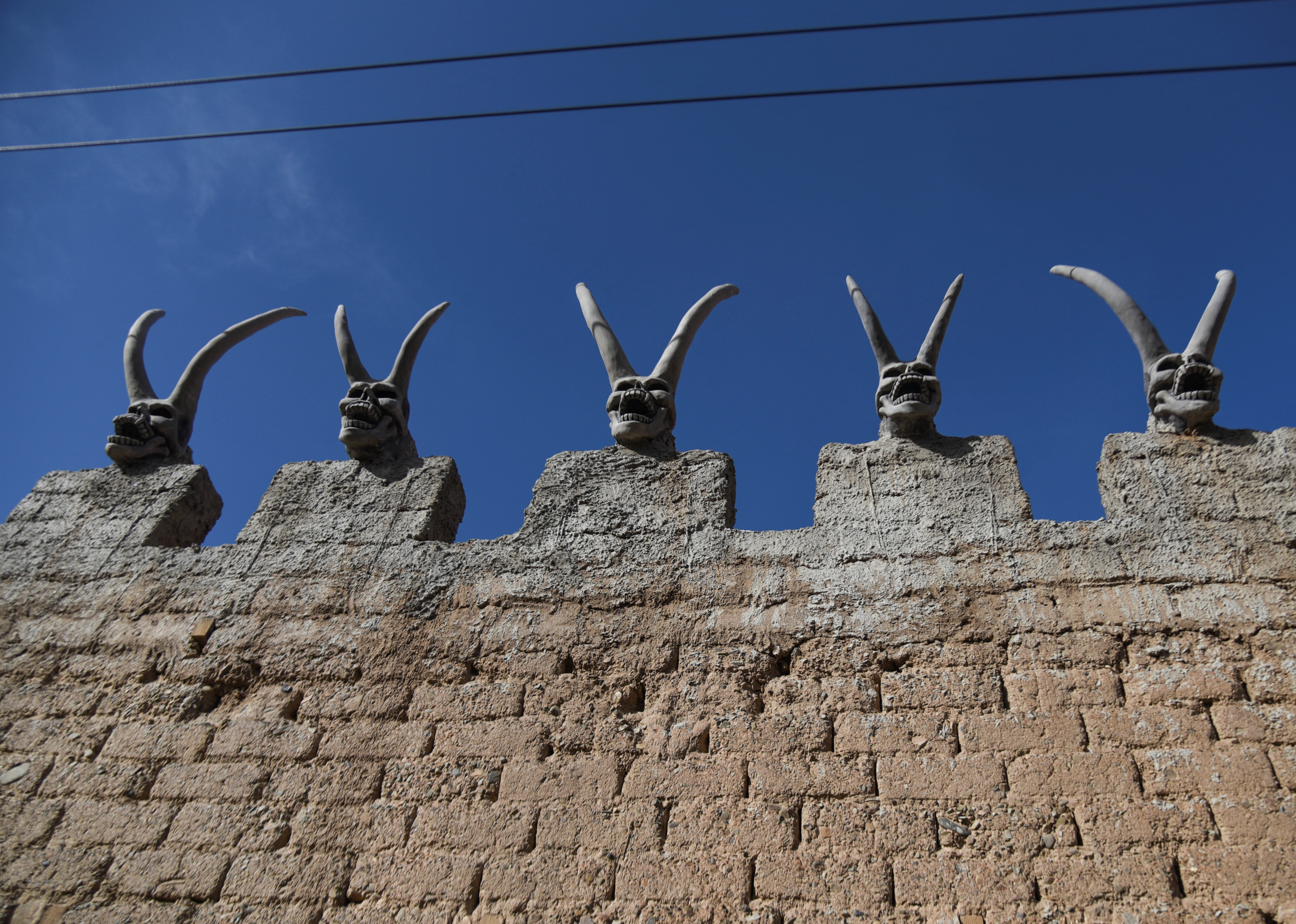 Sculptures of horned devils adorn the house of Bolivian miner David Choque, intended as a playful nod to the South American country's colonial past, but which has shocked some neighbors who fear a link to occult rituals, in El Alto, Bolivia February 16, 2022. REUTERS/Claudia Morales