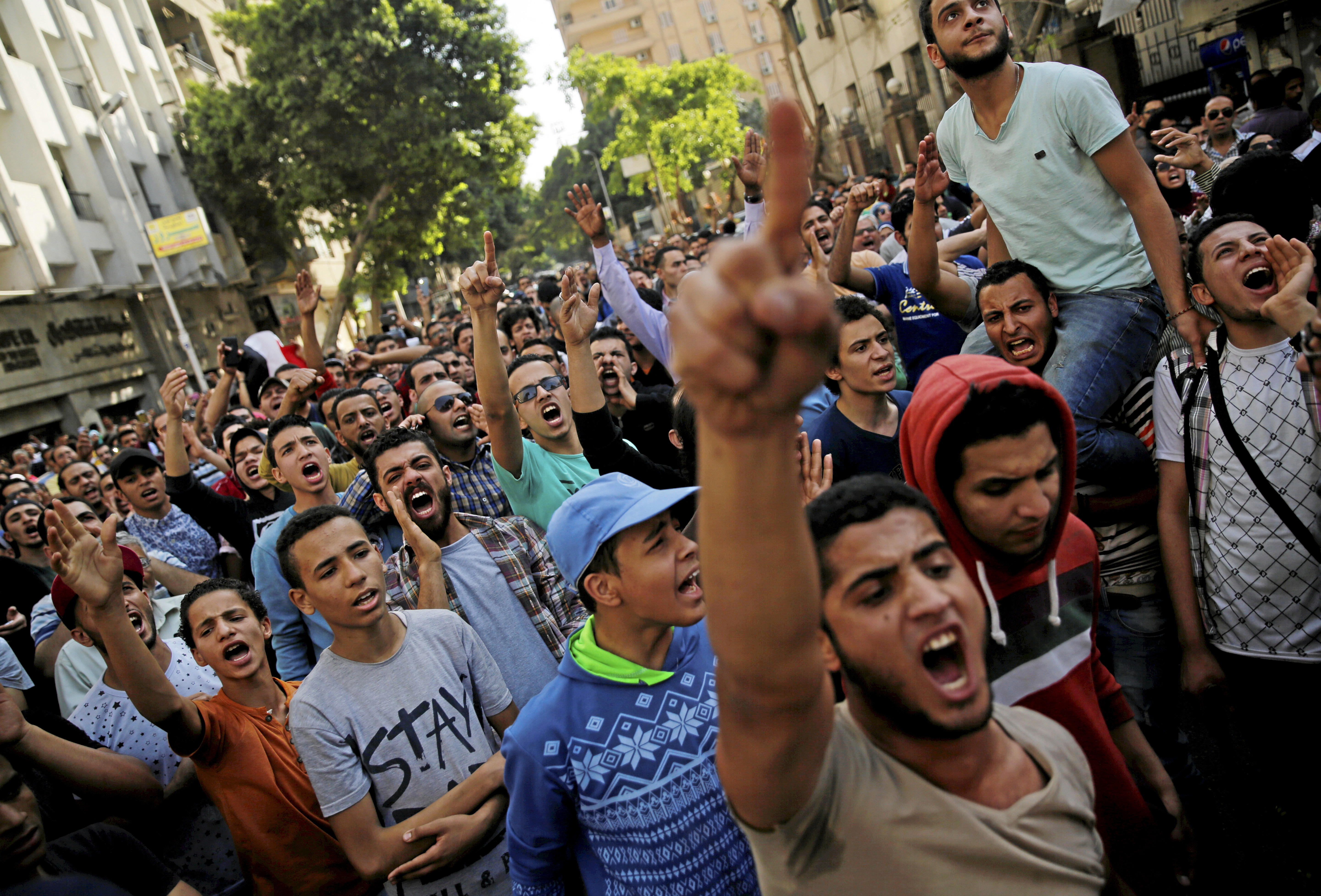 Egyptian protesters and Muslim Brotherhood members shout slogans against President Abdel Fattah al-Sisi and government during a demonstration protesting the government's decision to transfer two Red Sea islands to Saudi Arabia, in front of the Press Syndi