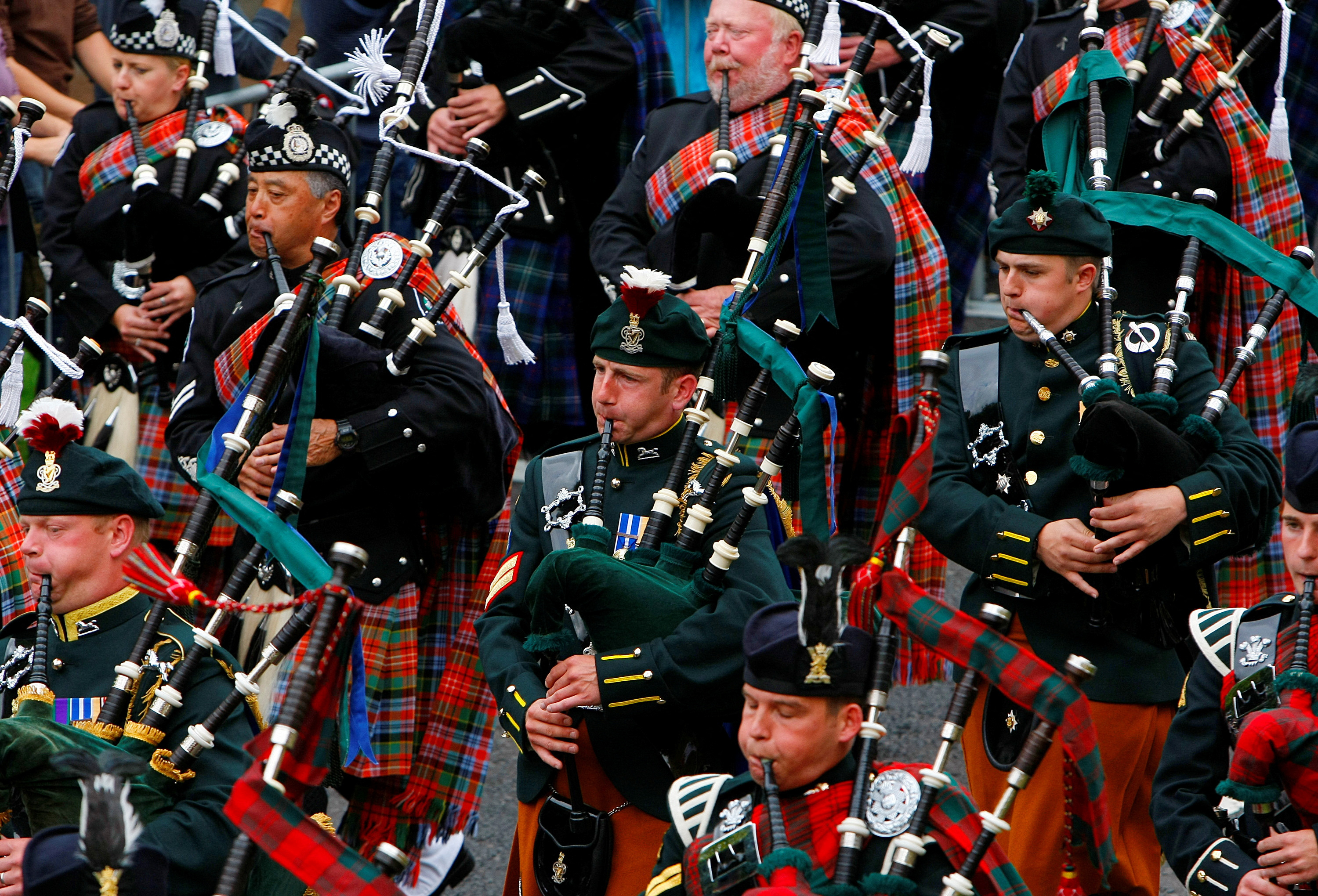 Pipers from the Edinburgh Military Tattoo Massed Pipes and Drums perform during the Edinburgh Fringe Festival parade in Holyrood Park in Edinburgh, Scotland