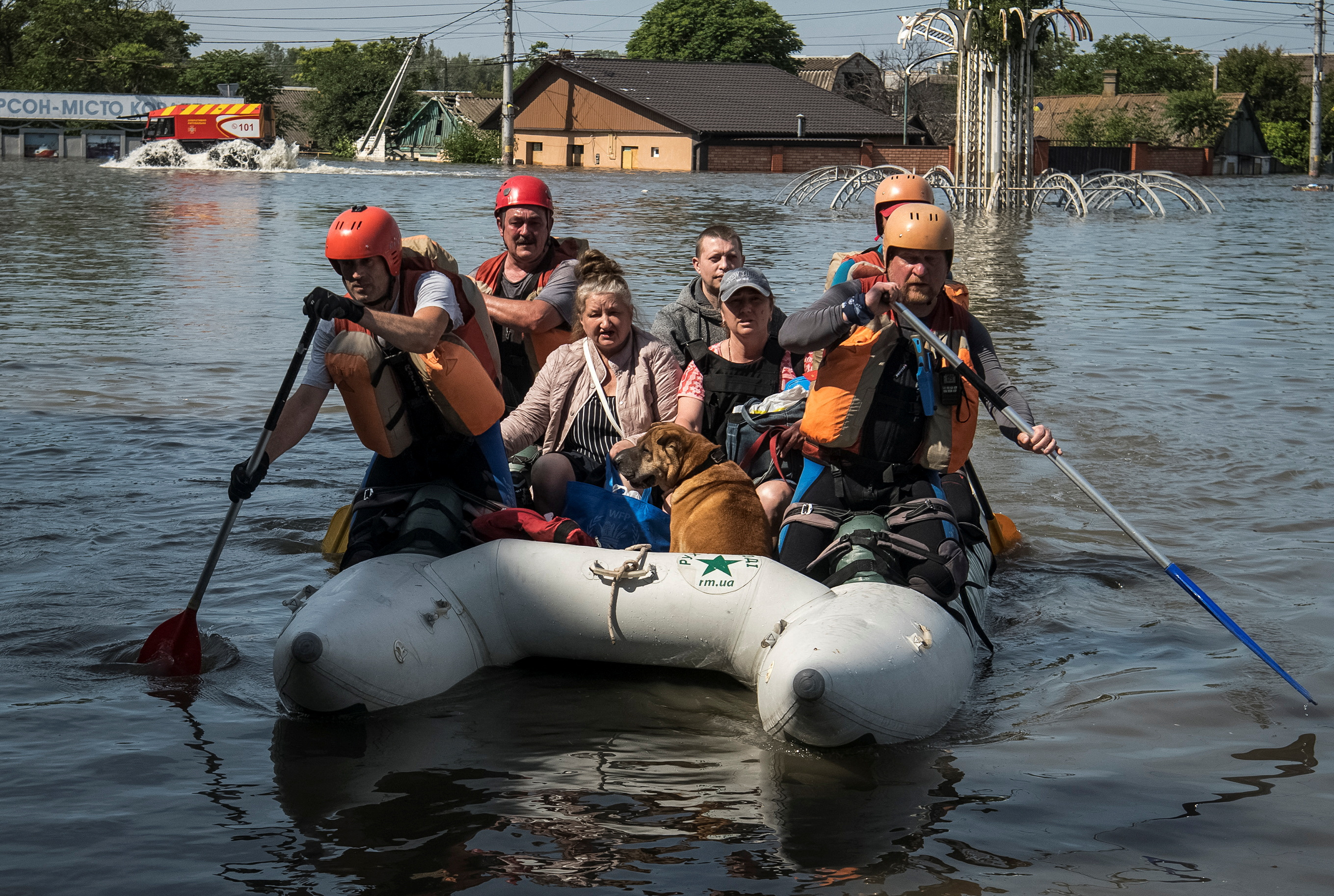 Rescuers evacuate local residents from a flooded area after the Nova Kakhovka dam breached, in Kherson