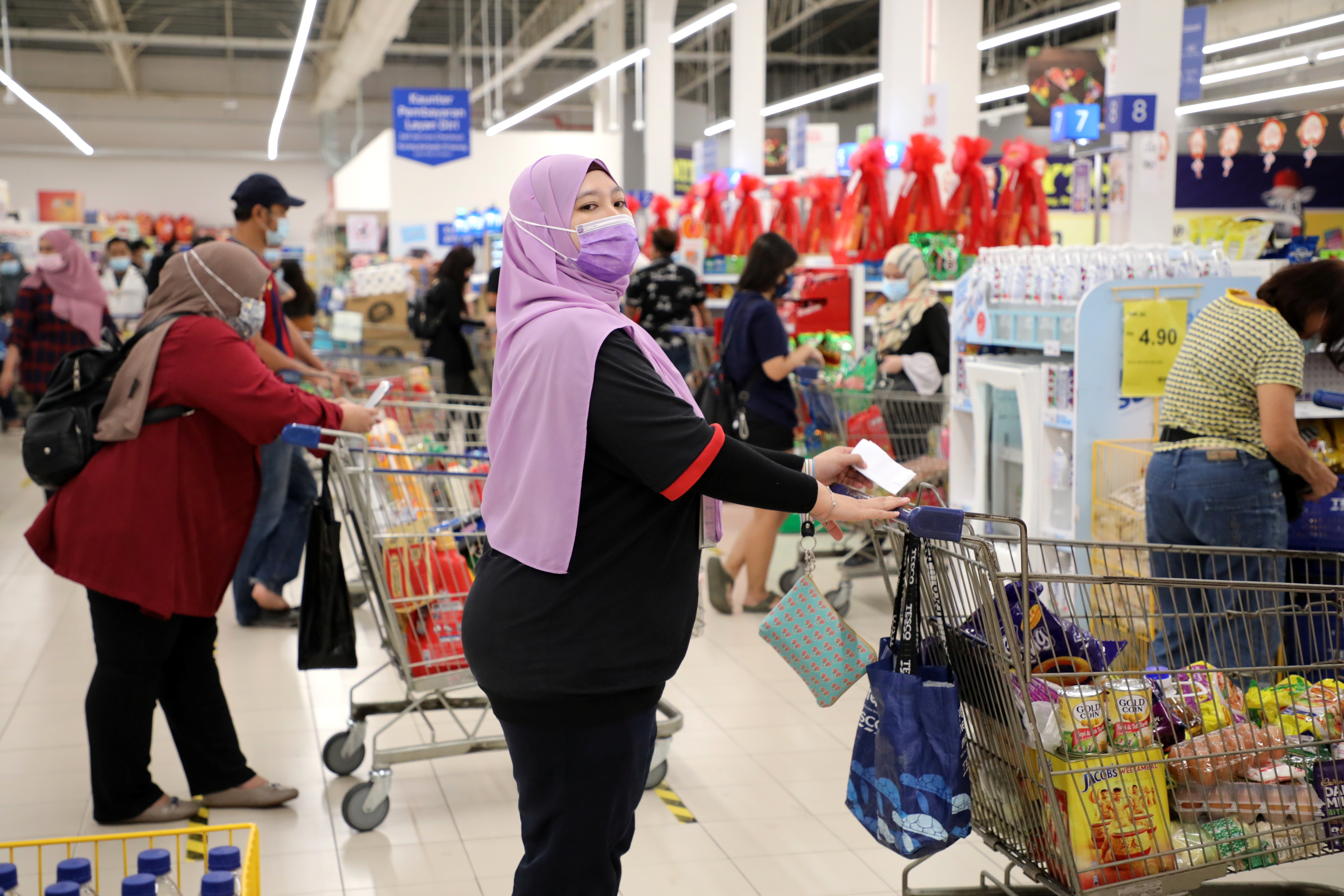 People line up to pay at a supermarket, amid the coronavirus disease (COVID-19) outbreak in Kuala Lumpur