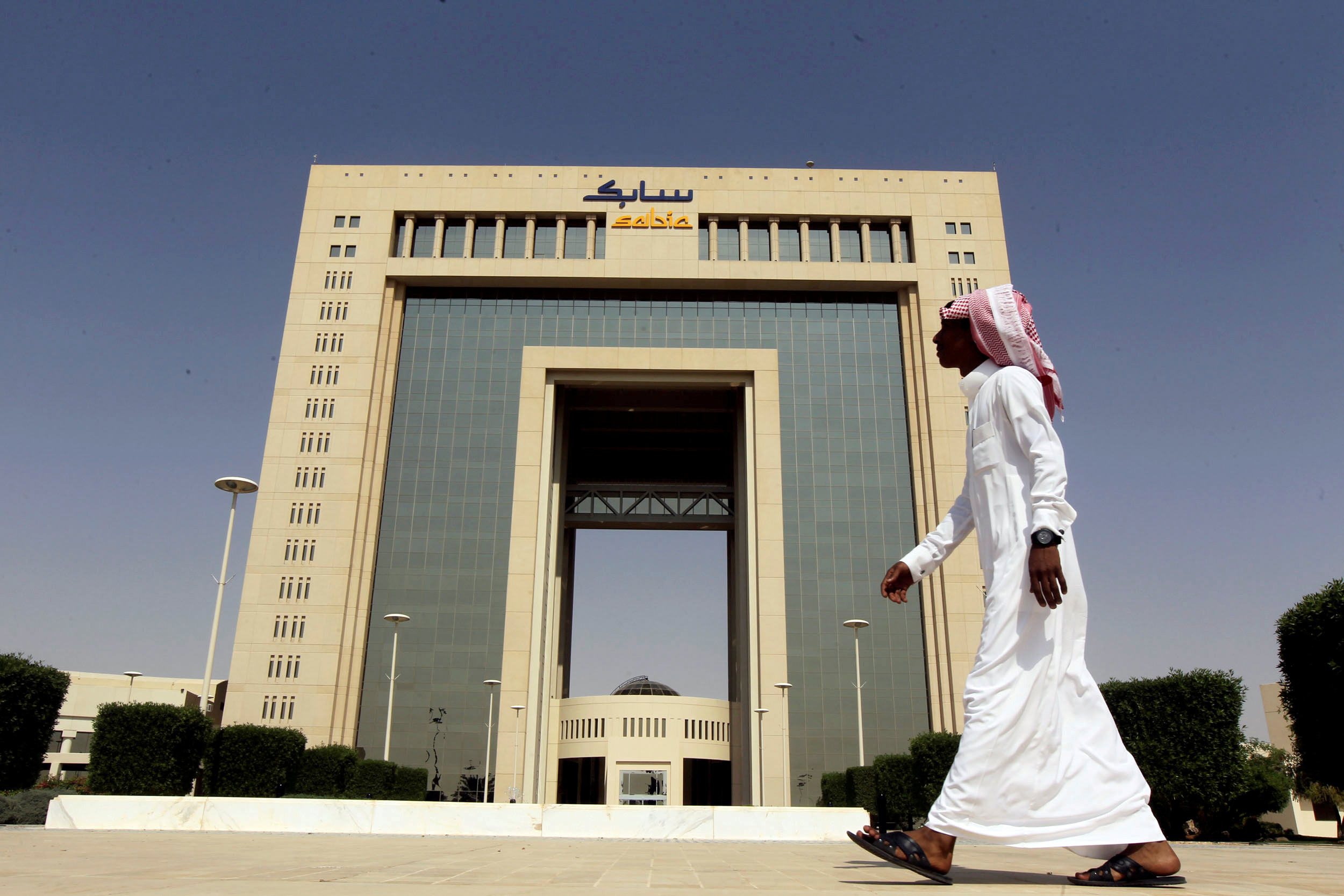A man walks past the headquarters of Saudi Basic Industries Corp (SABIC) in Riyadh