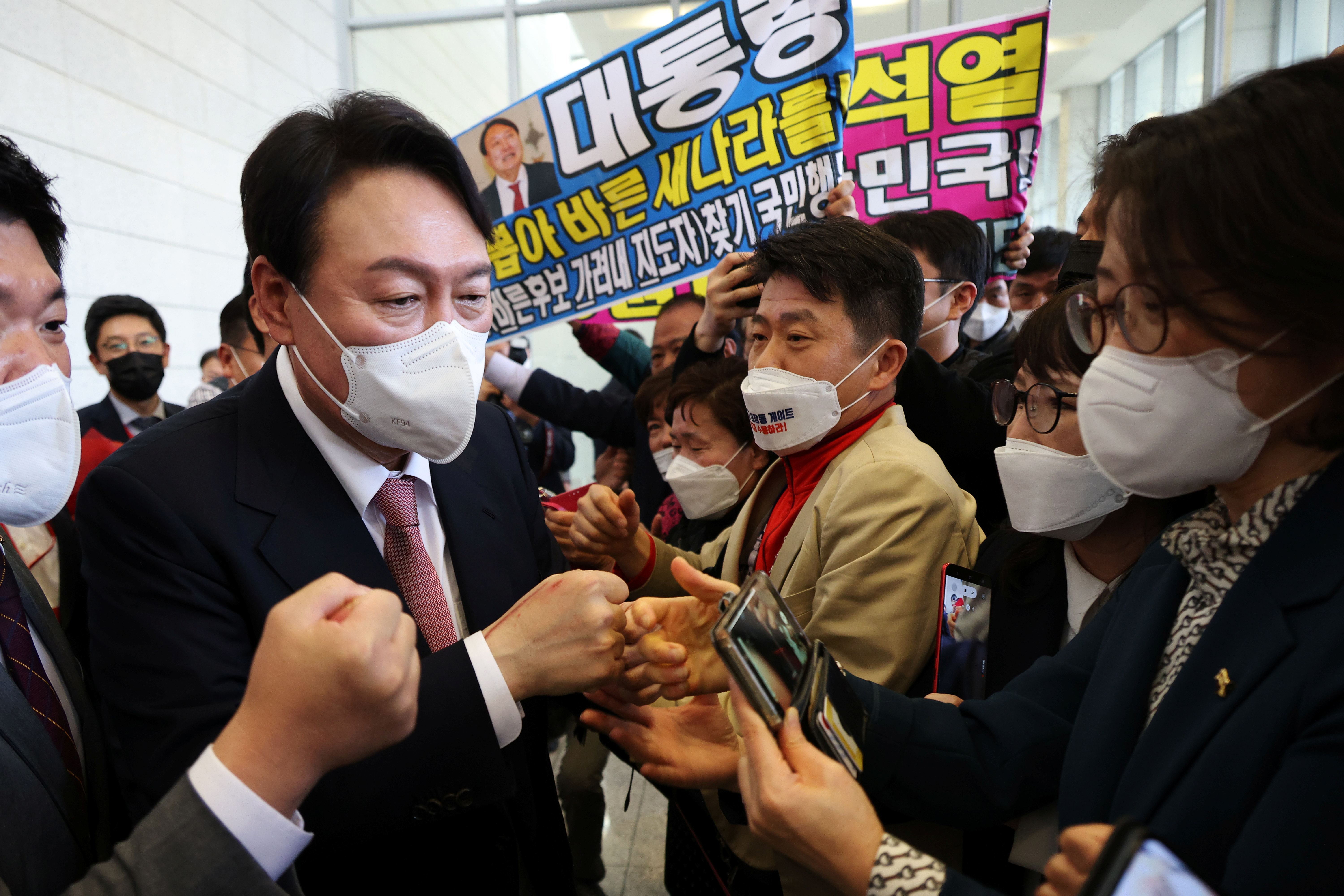 South Korea's main opposition People Power Party's contender for next year's presidential election, former Prosecutor General Yoon Seok-Youl, celebrates with his supporters after being chosen as the presidential election candidate, in Seoul
