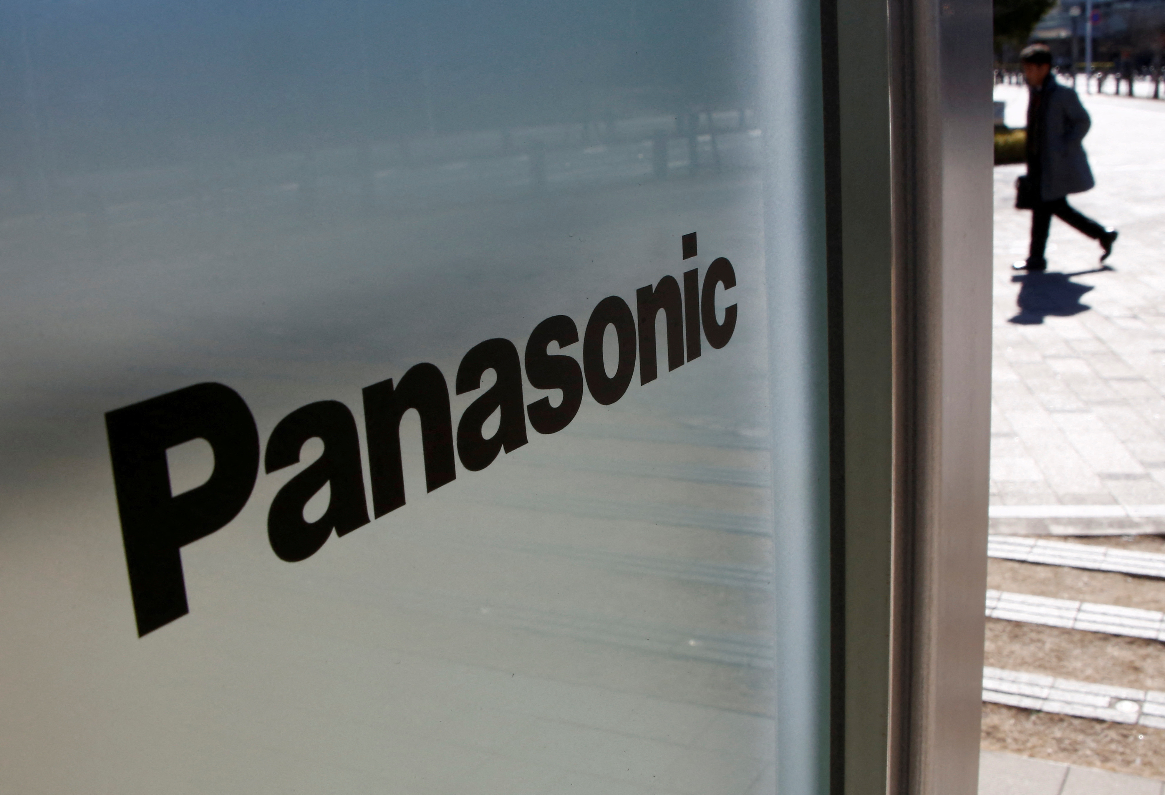 A man is seen next to a Panasonic logo at Panasonic Center in Tokyo