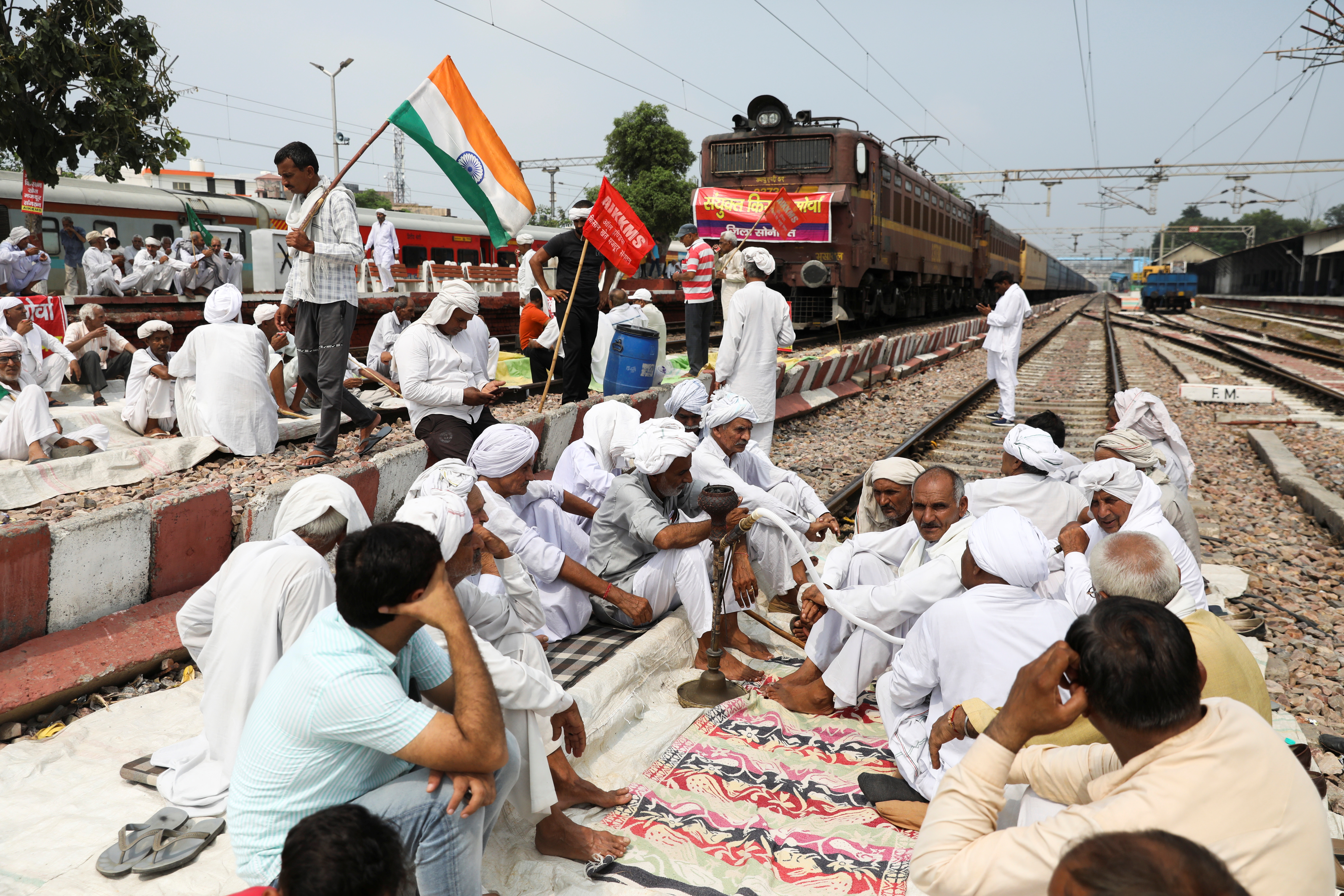 Farmers block railway tracks as part of protests against farm laws during nationwide protests, in Sonipat, northern state of Haryana, India, September 27, 2021. REUTERS/Anushree Fadnavi