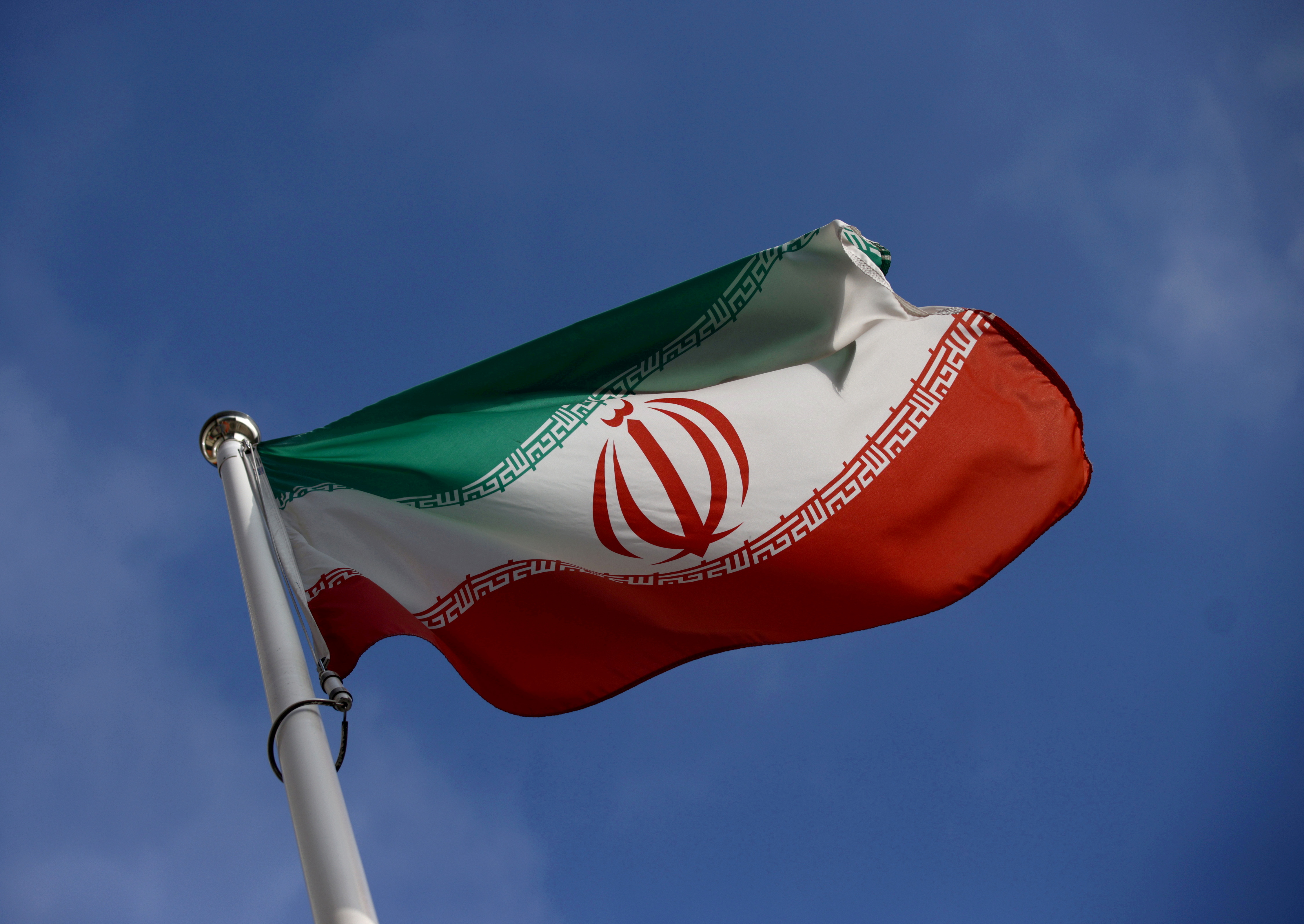 The Iranian flag waves in front of the International Atomic Energy Agency (IAEA) headquarters, before the beginning of a board of governors meeting, in Vienna, Austria, March 1, 2021. REUTERS/Lisi Niesner/File Photo