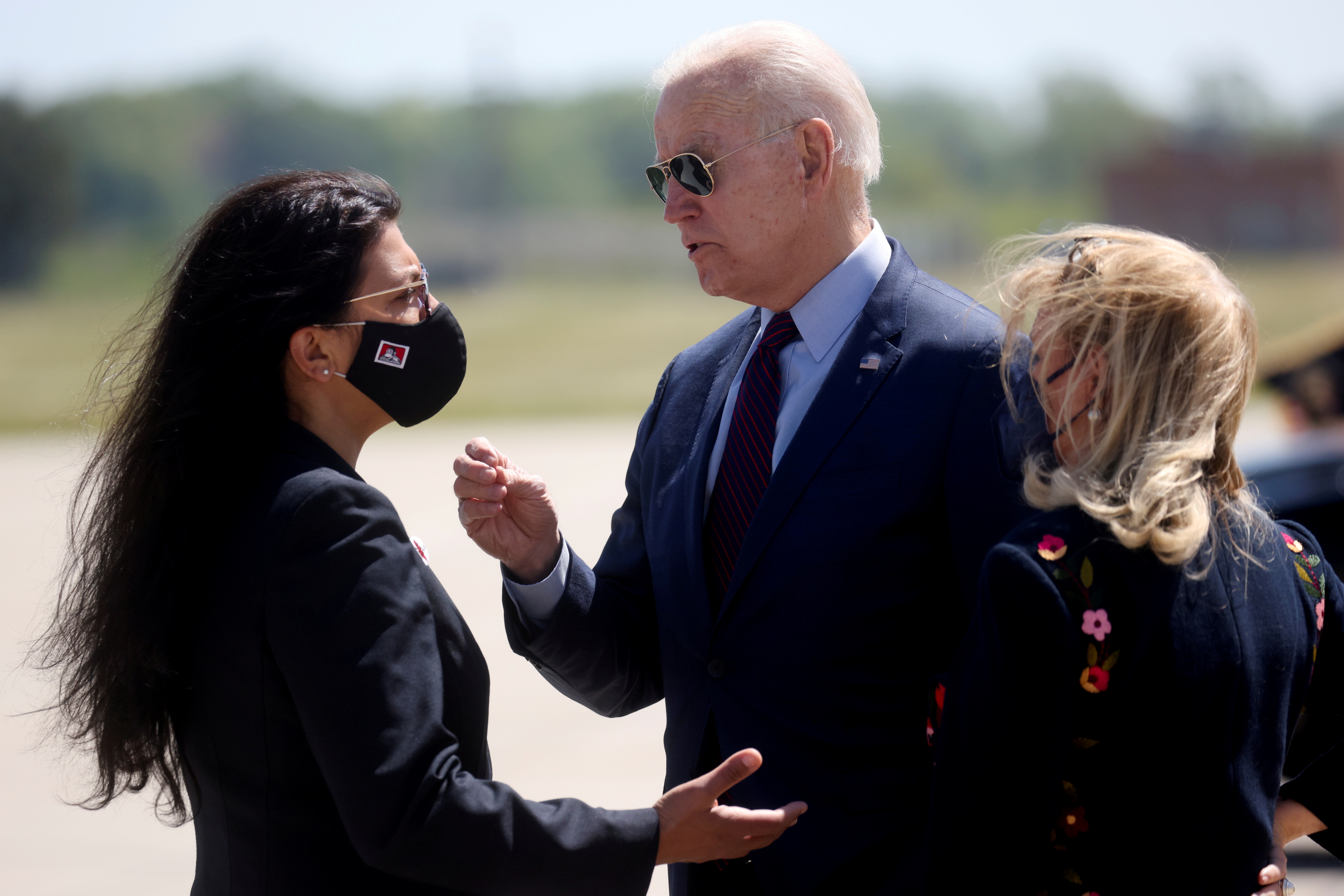 U.S. President Joe Biden is greeted by U.S. Rep. Debbie Dingell (D-MI) and U.S. Rep. Rashida Tlaib at Detroit Metropolitan Wayne County Airport