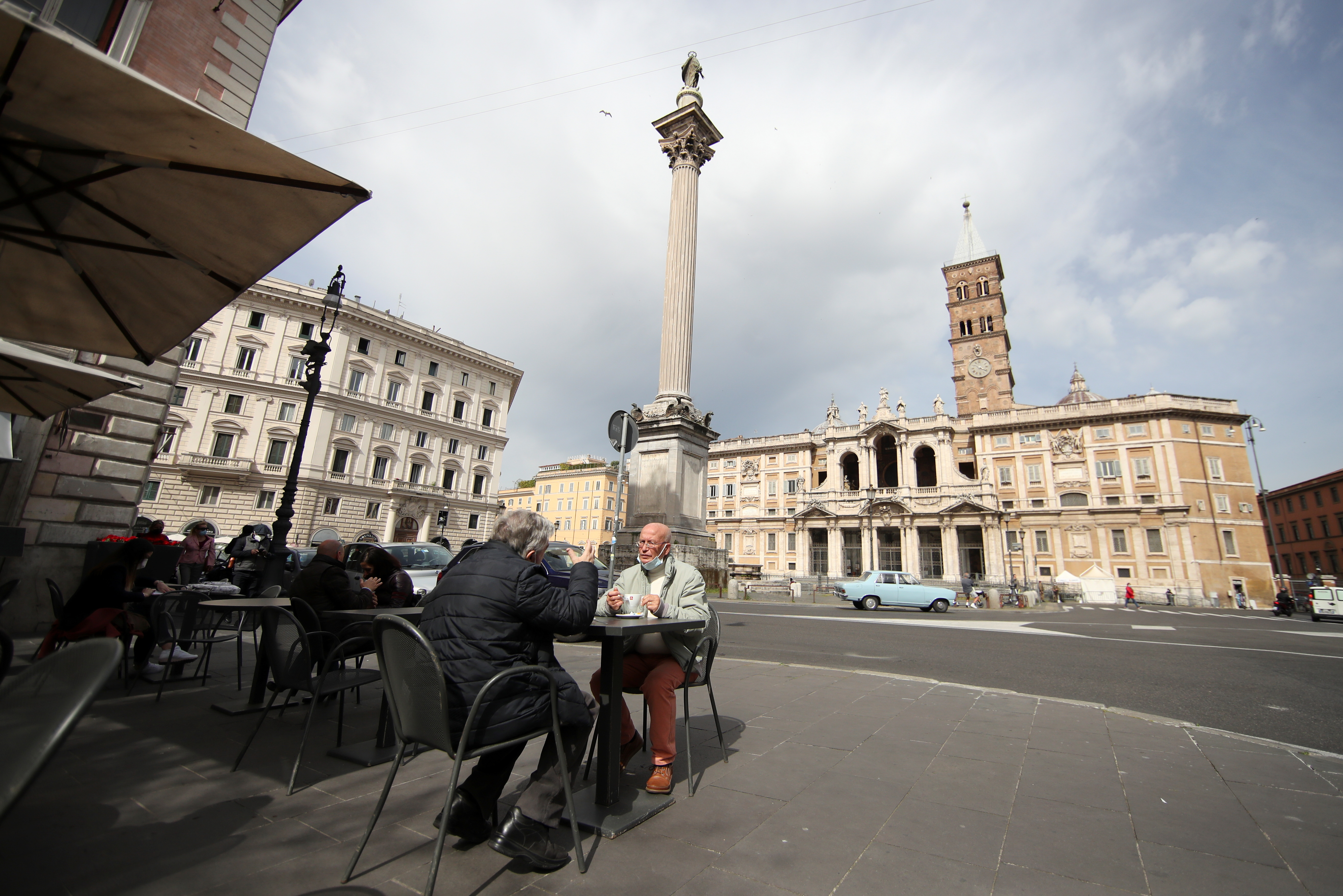 People have breakfast at the terrace of a bar at Santa Maria Maggiore's Square, as much of the country becomes a 'yellow zone', easing coronavirus disease (COVID-19) restrictions and allowing bars and restaurants to open for sit-down food and drinks at outdoor tables, in Rome, Italy, April 26, 2021. REUTERS/Yara Nardi