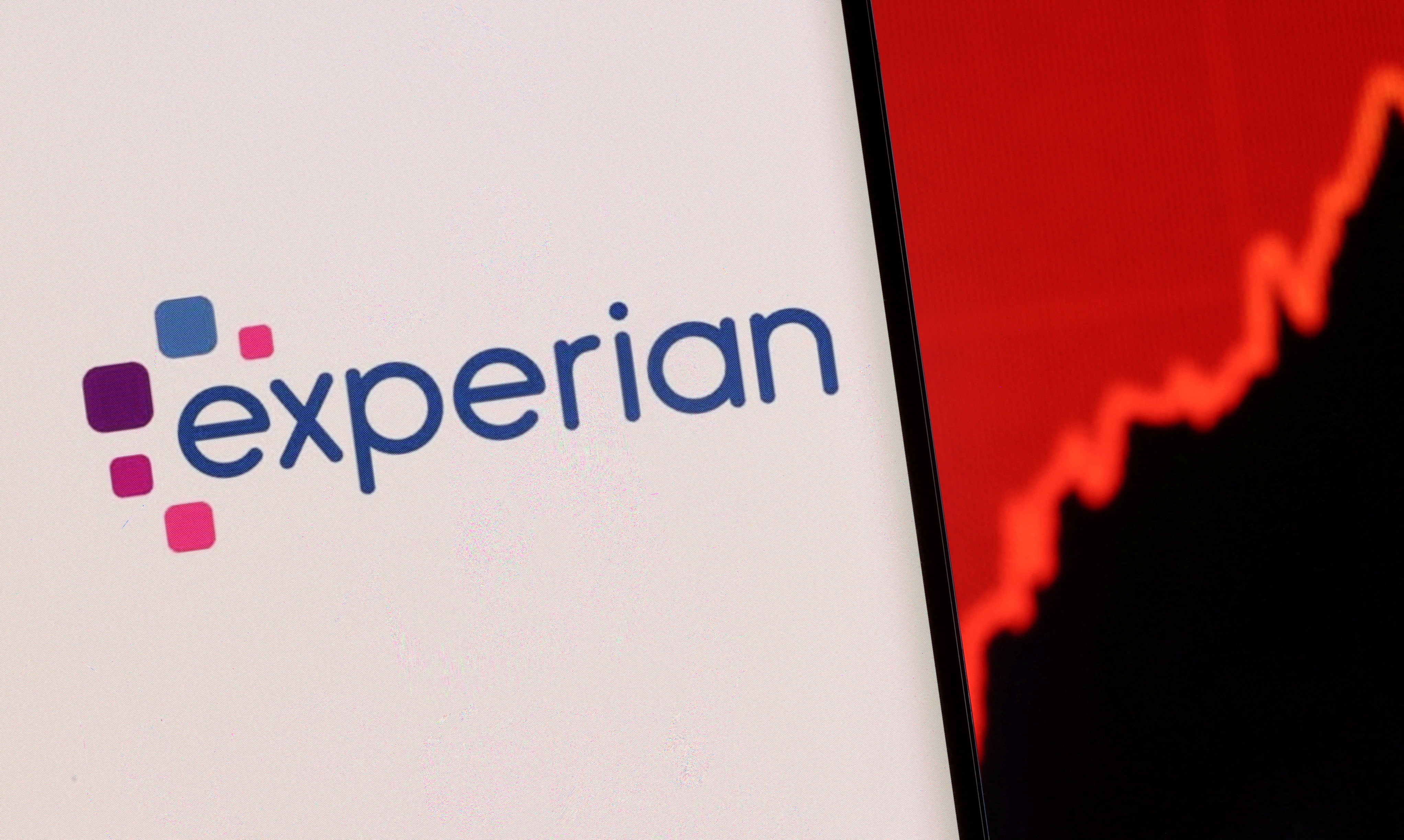 FILE PHOTO: Illustration shows a smartphone with displayed Experian logo and stock graph