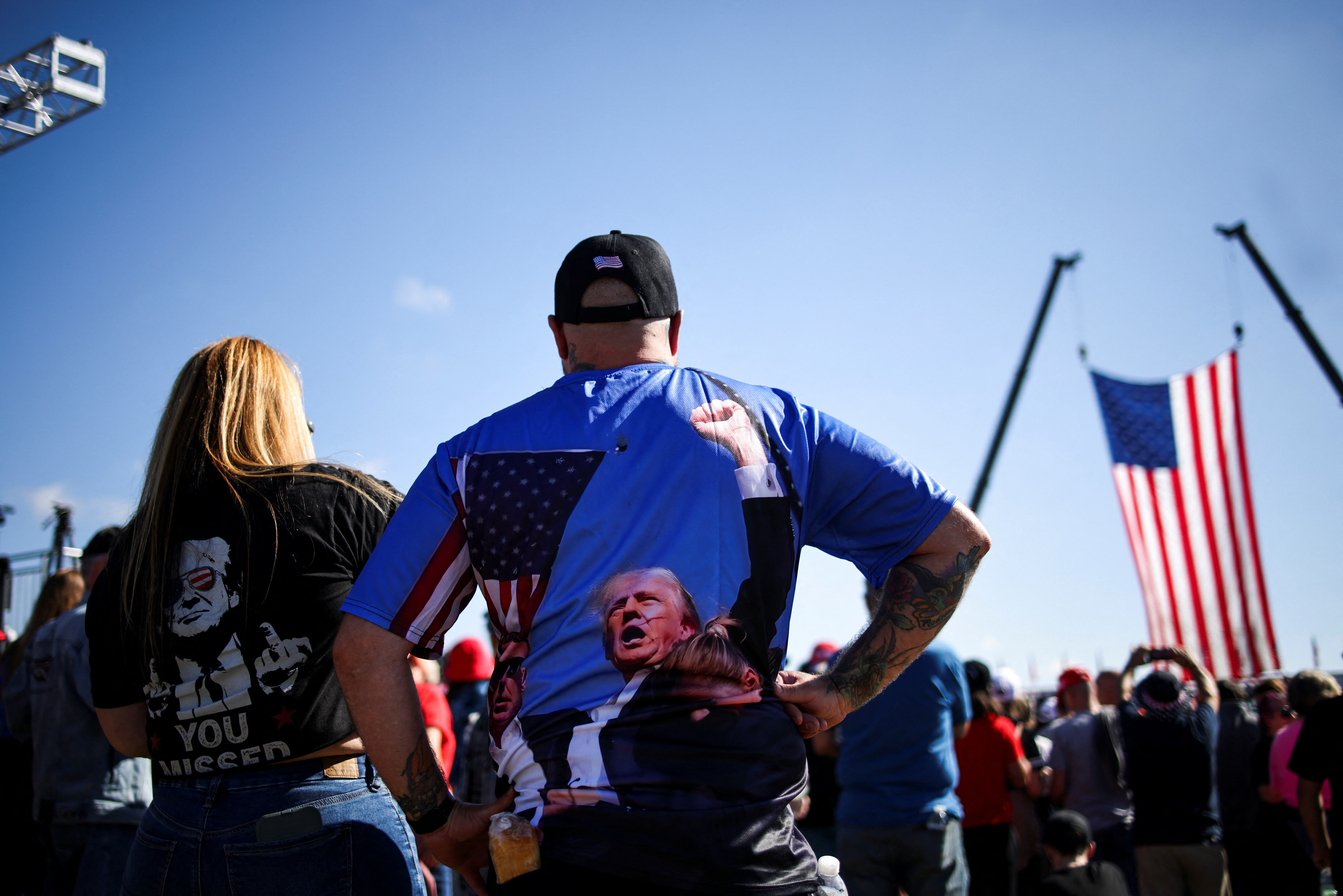 People wear shirts in support of Republican presidential nominee and former U.S. president Donald Trump, on the day Trump returns to the site of the July assassination attempt against him in Butler, Pennsylvania, U.S., October 5, 2024. REUTERS/Carlos Barria