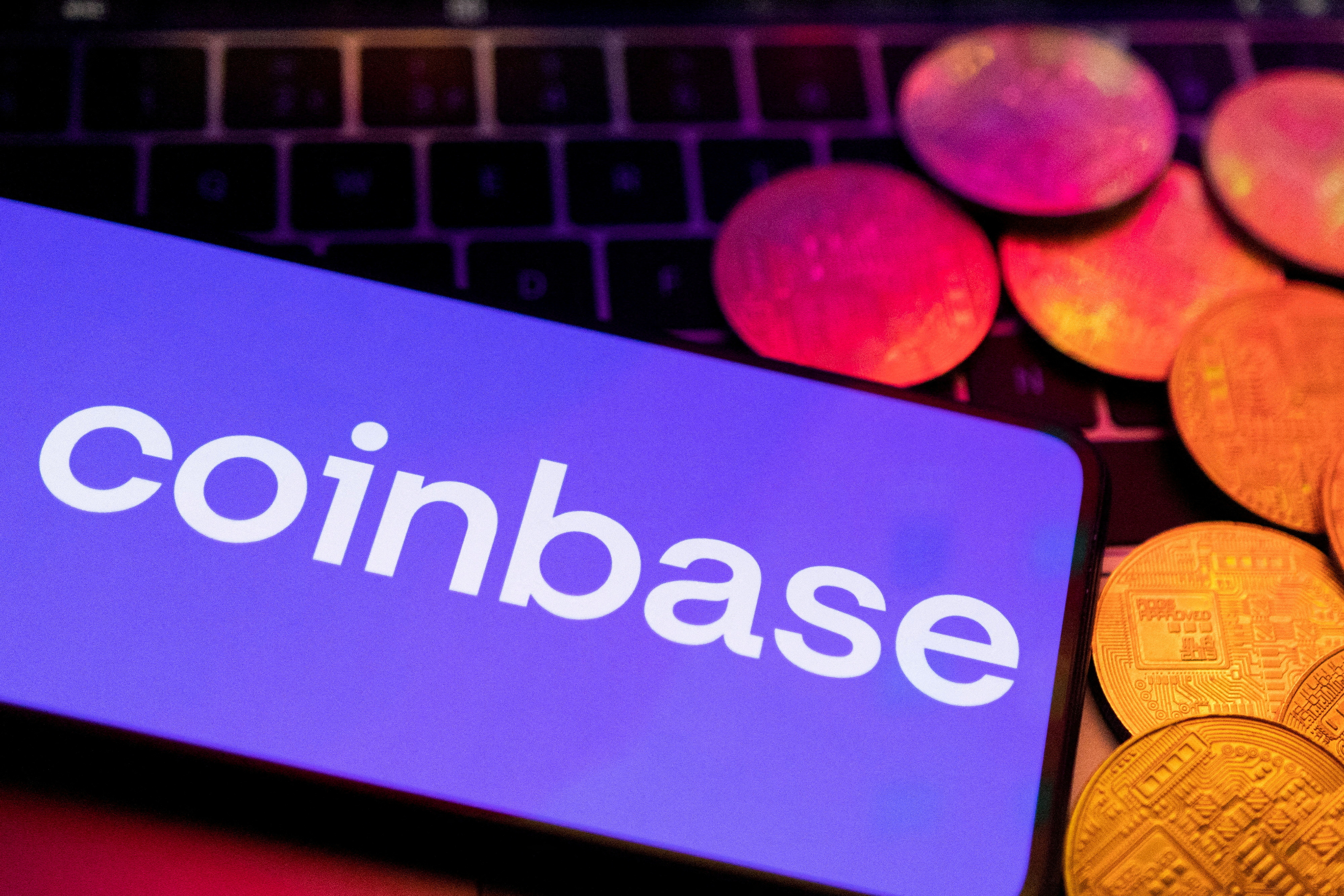 Illustration shows smartphone with displayed Coinbase logo
