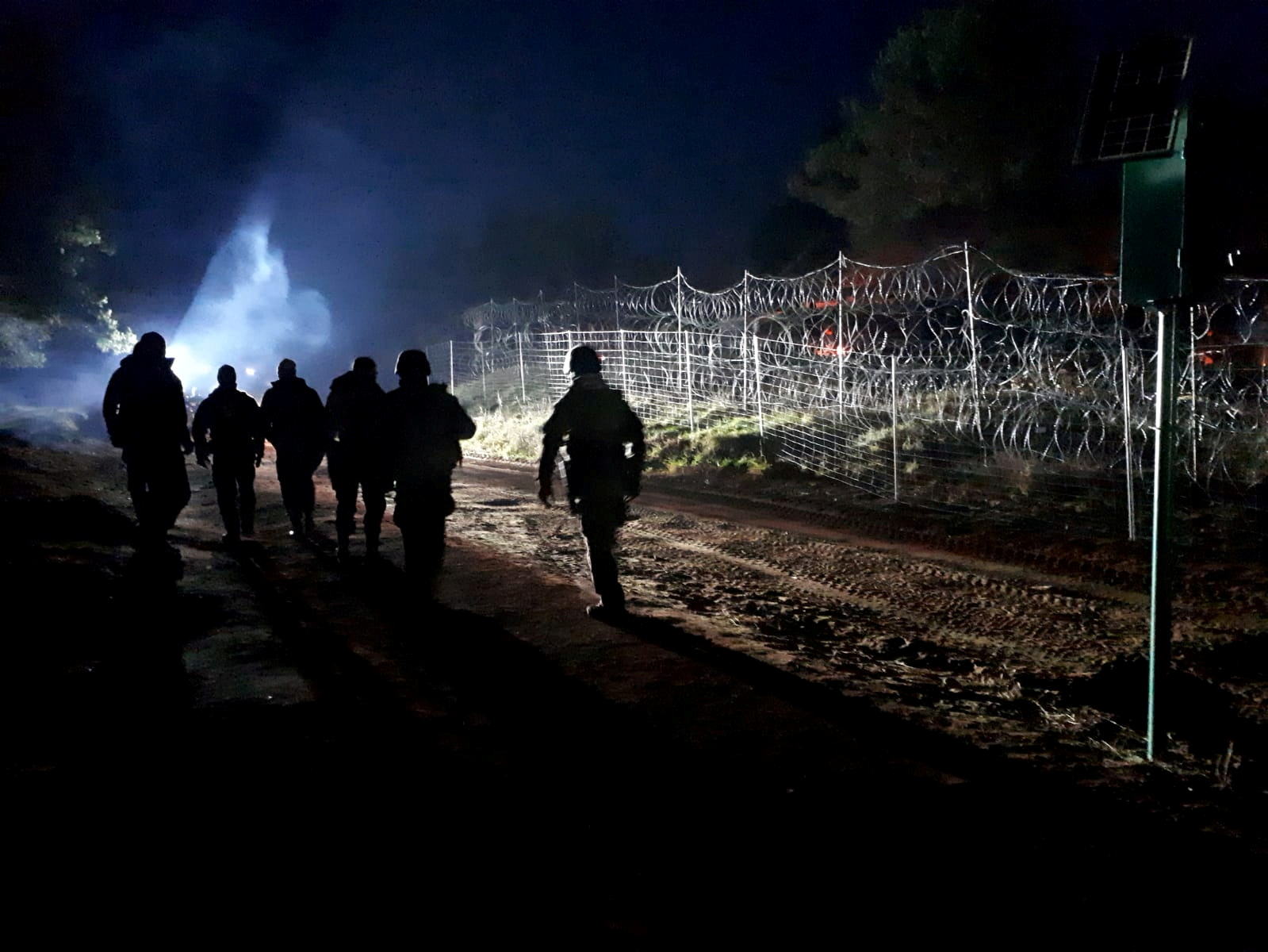 Polish soldiers patrol Poland/Belarus border near Kuznica, Poland, in this photograph released by the Polish Ministry of Defence, November 11, 2021. MON/Handout via REUTERS