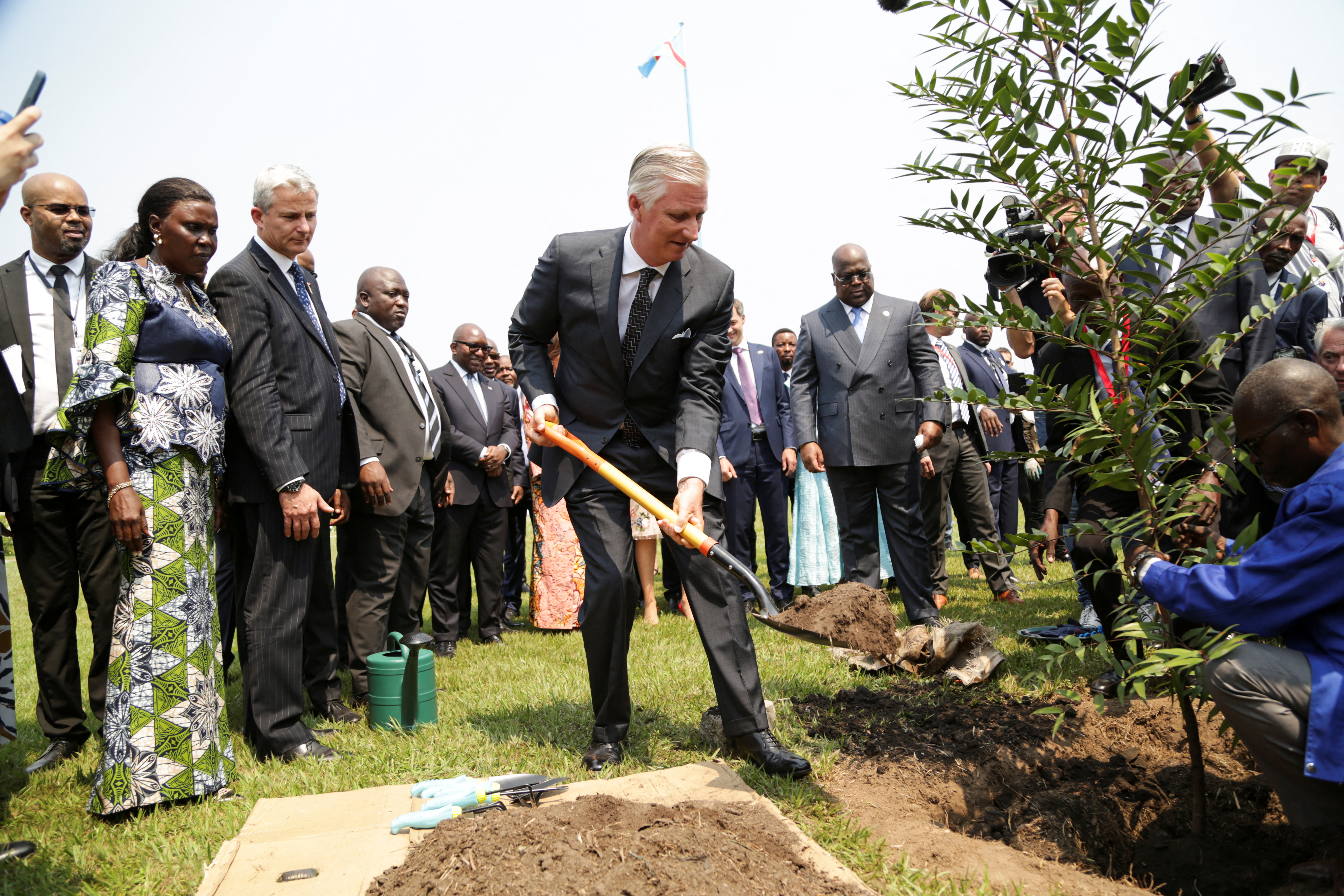 Belgium's King Philippe plants a tree at the Palais de la Nartion courtyard, during his official visit in Kinshasa