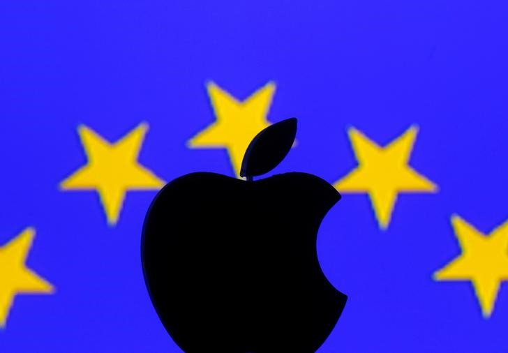 A 3D printed Apple logo is seen in front of a displayed European Union flag in this illustration