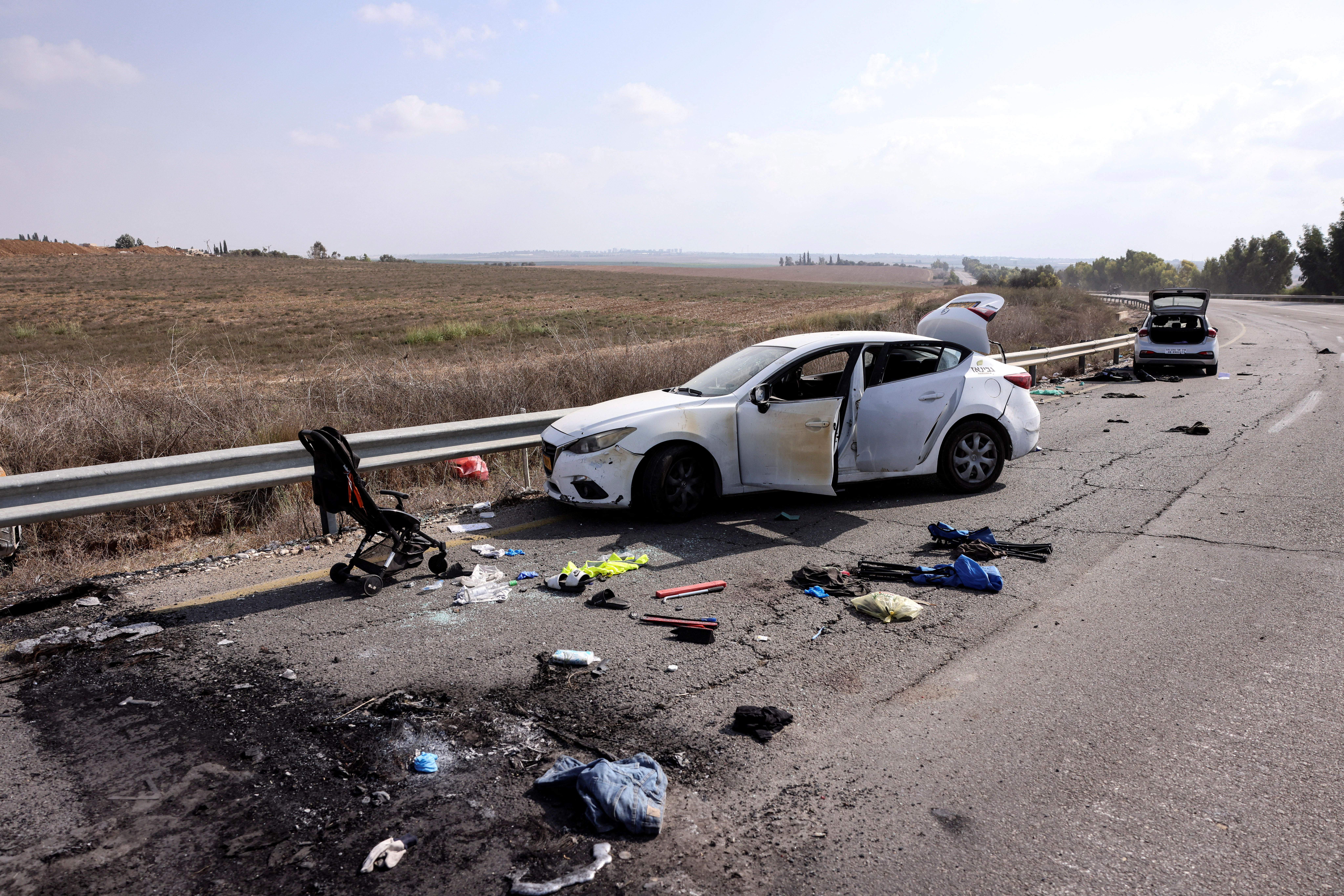 Personal belongings including a child's pram are seen on the road days after a mass infiltration by Hamas gunmen from the Gaza Strip, near Kibbutz Kfar Aza, in southern Israel