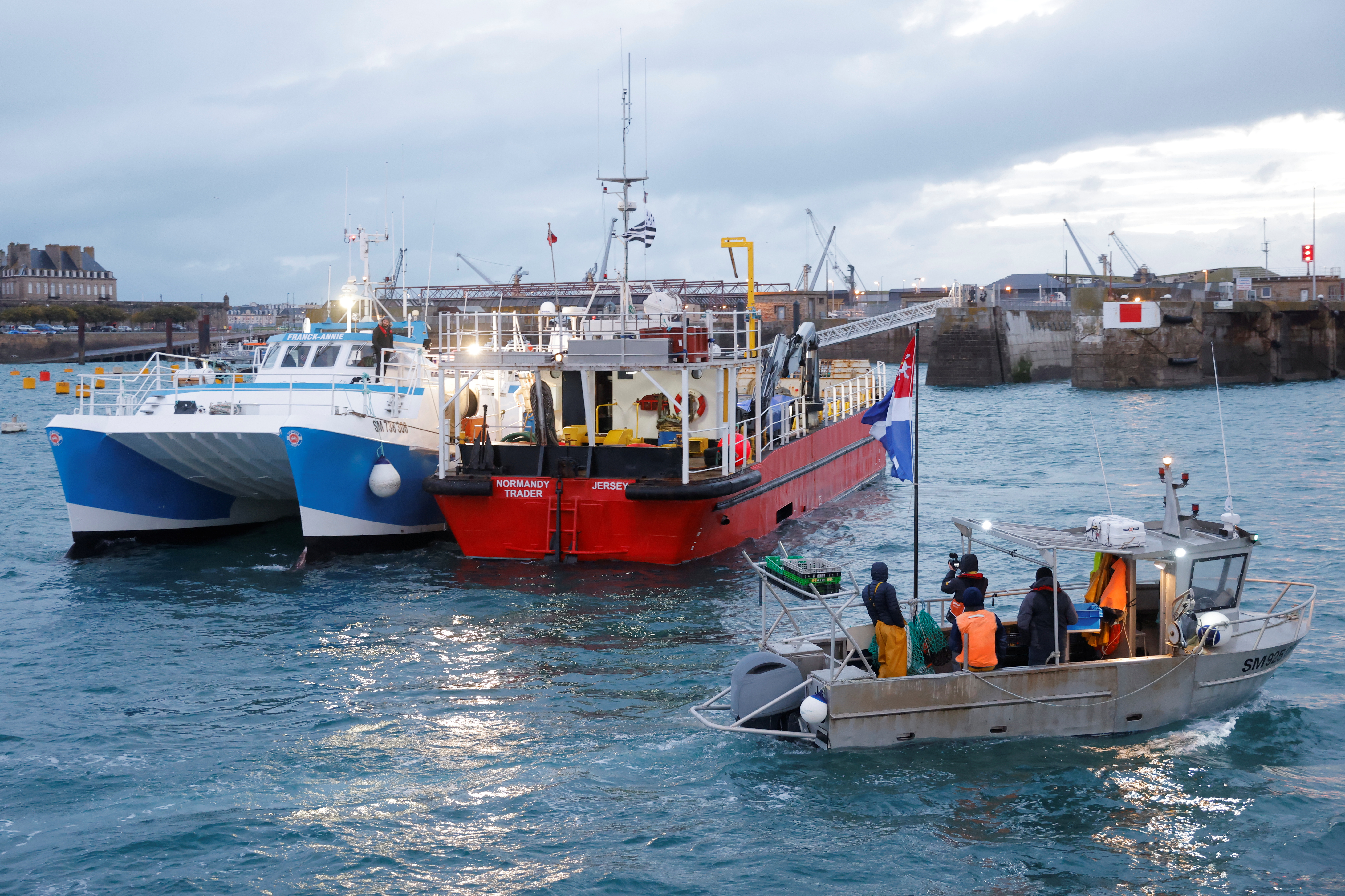 French fishermen block the 'Normandy Trader' boat at the entrance of the port of Saint-Malo as they started a day of protests to mark their anger over the issue of post-Brexit fishing licenses, in Saint-Malo, France, November 26, 2021. REUTERS/Stephane Mahe