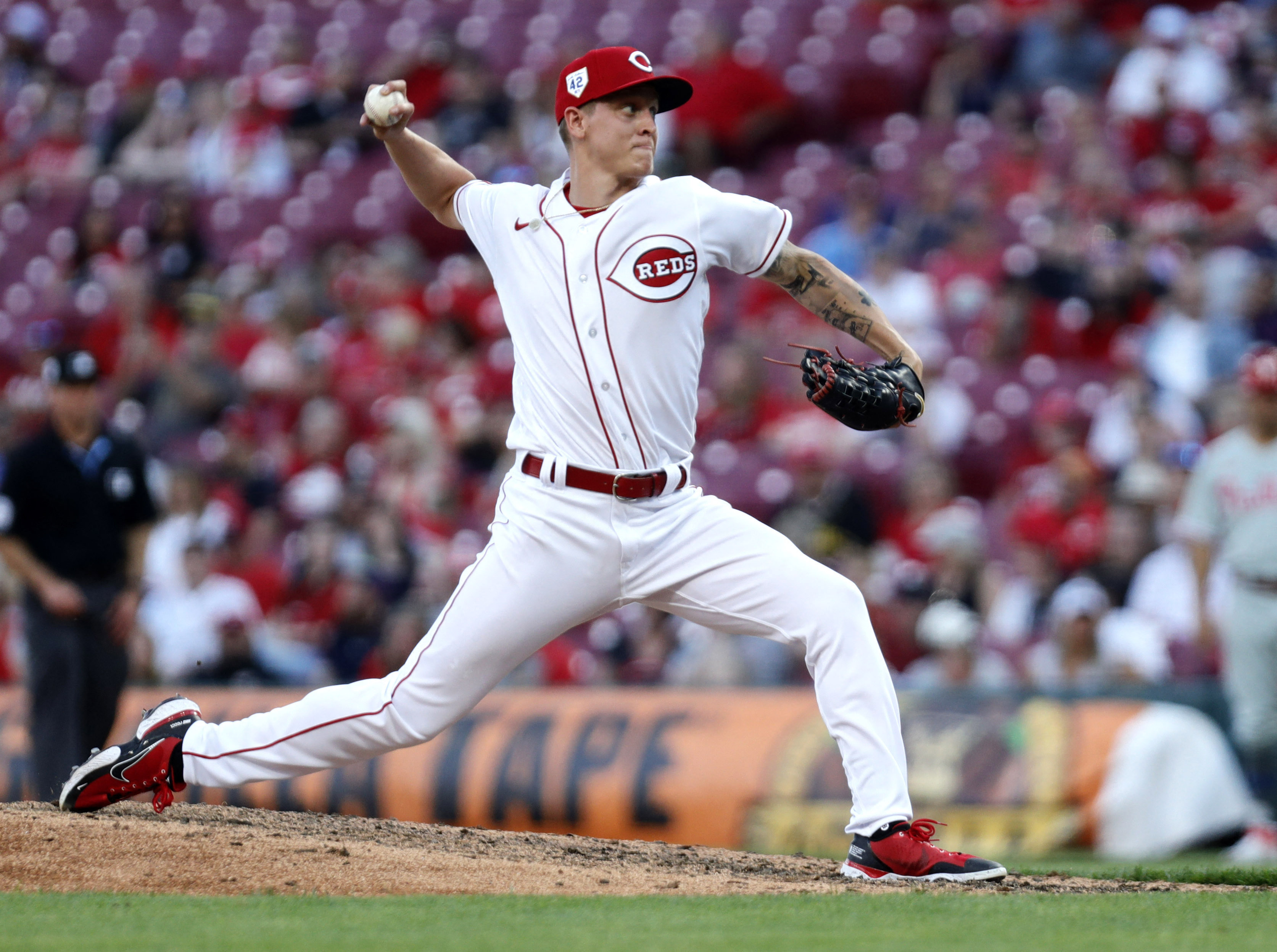 The socks and cleats worn by Cincinnati Reds' Jonathan India are seen as  takes his lead from first base during a baseball game against the St. Louis  Cardinals in Cincinnati, Thursday, May