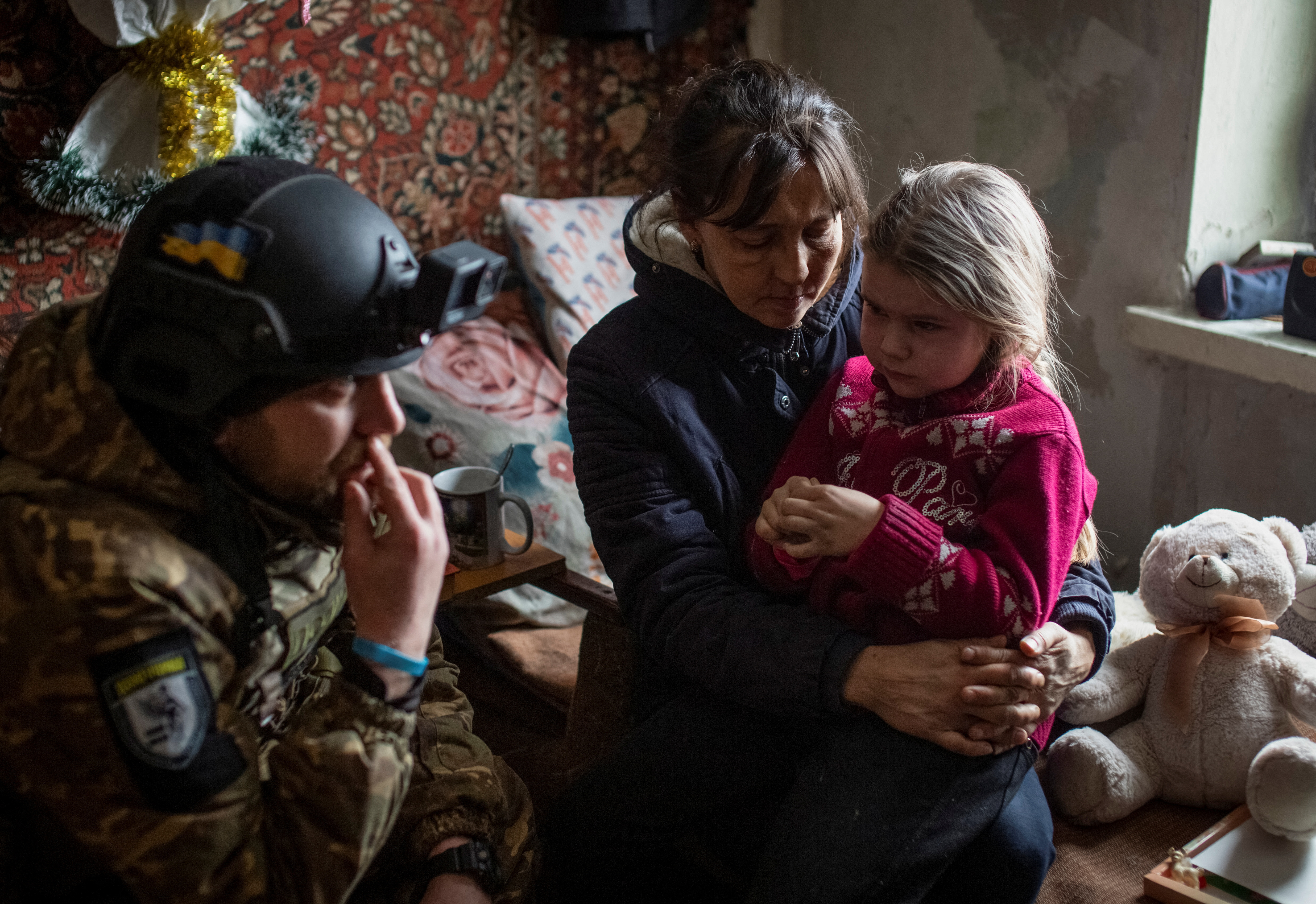 A grandmother hugs her granddaughter Arina before evacuation from front line city of Bakhmut