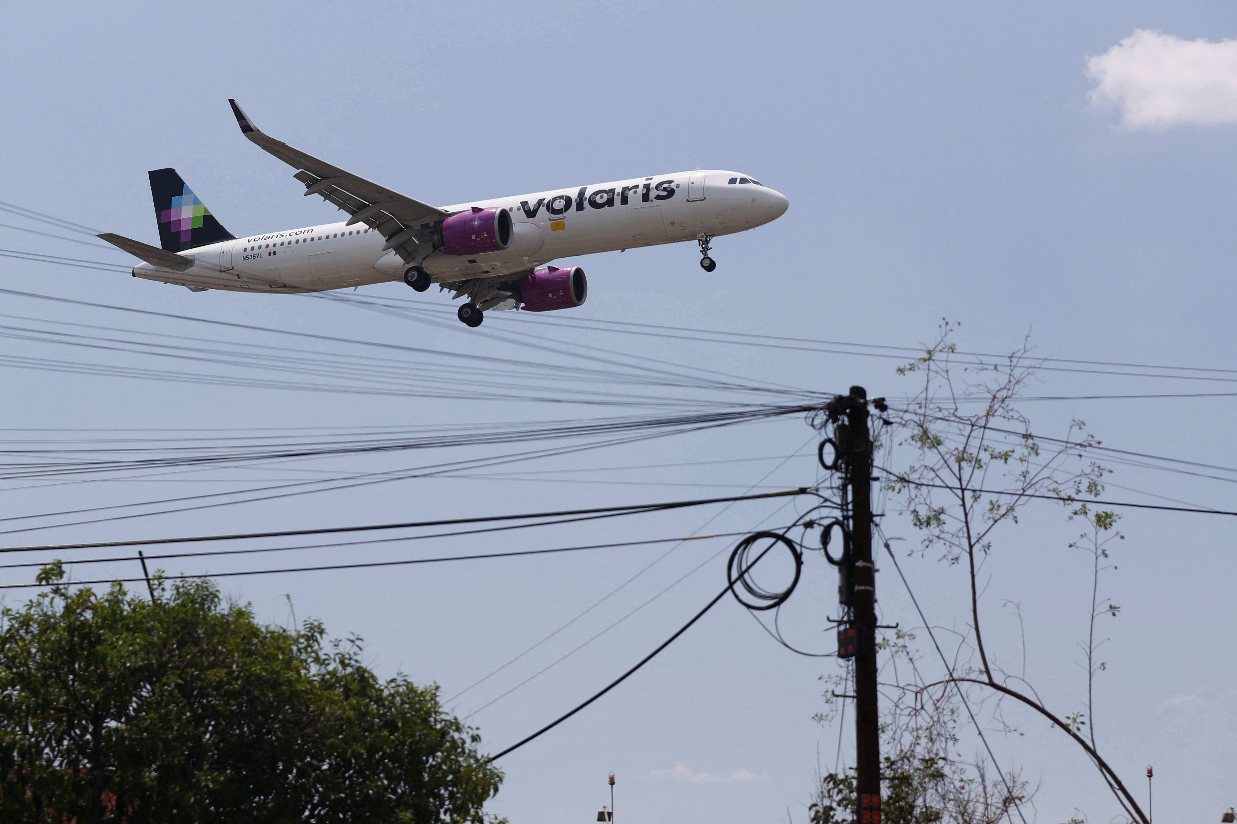 A Volaris airplane prepares to land on the airstrip at Benito Juarez international airport in Mexico City