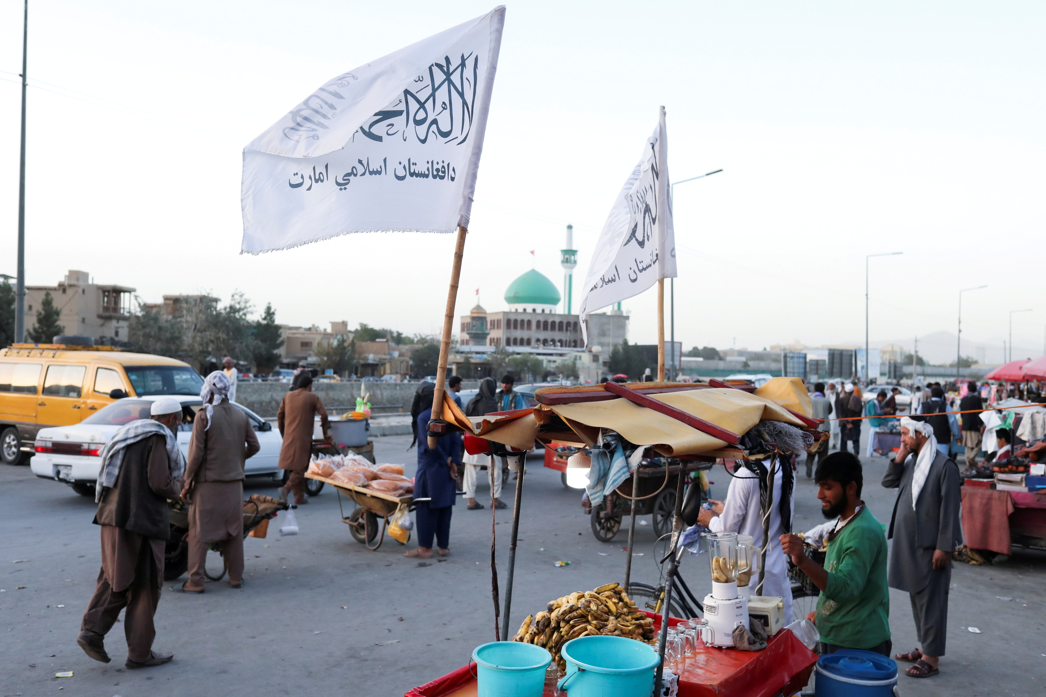 The Taliban flags are seen on a street in Kabul