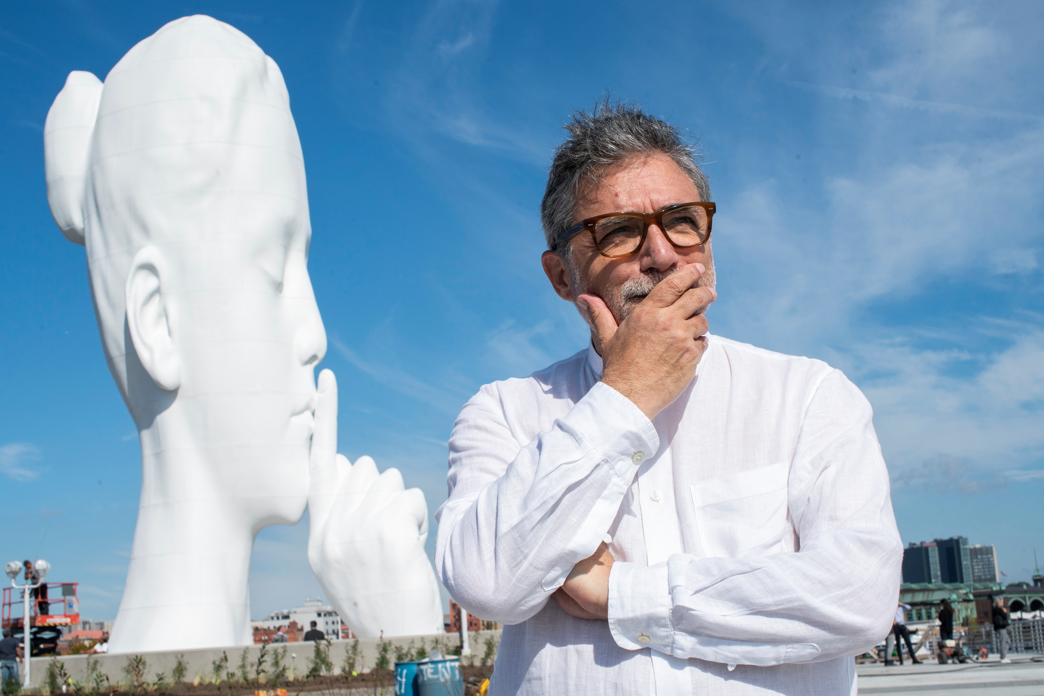 Artist Jaume Plensa poses for a photo near his statue 