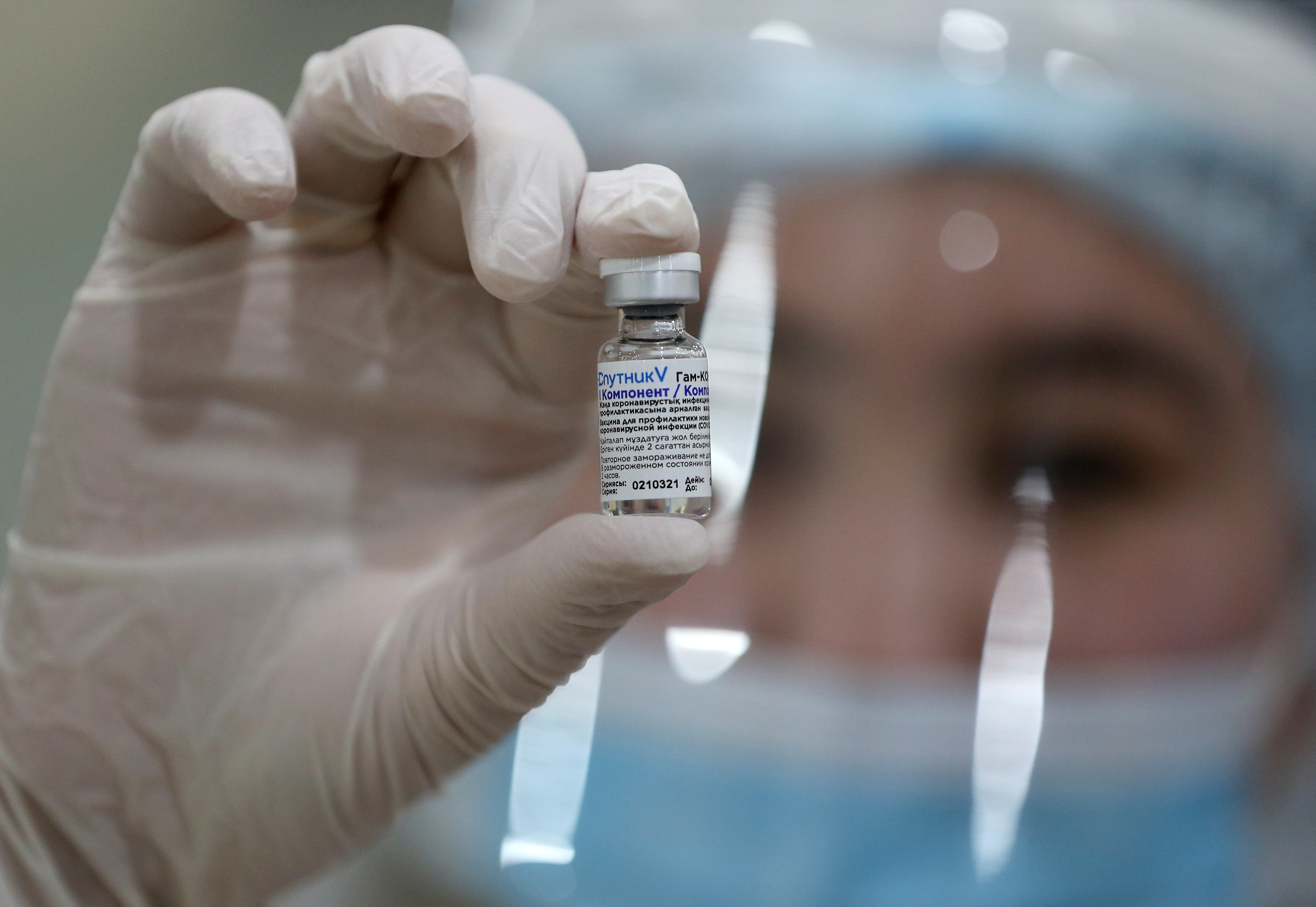 A medical worker holds a vial with COVID-19 vaccine in Almaty