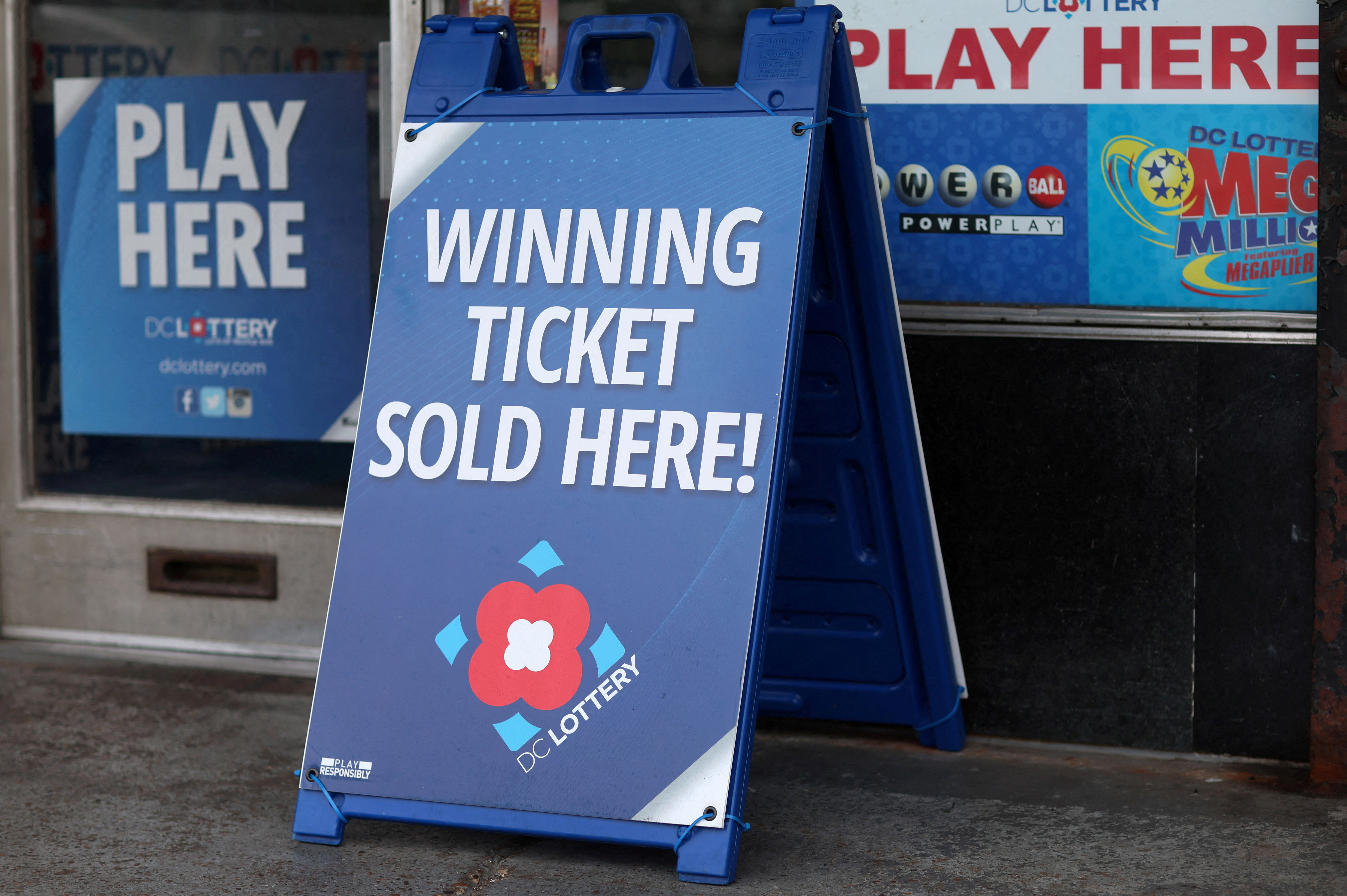 Lotto ticket signs advertising Mega Millions and the Powerball