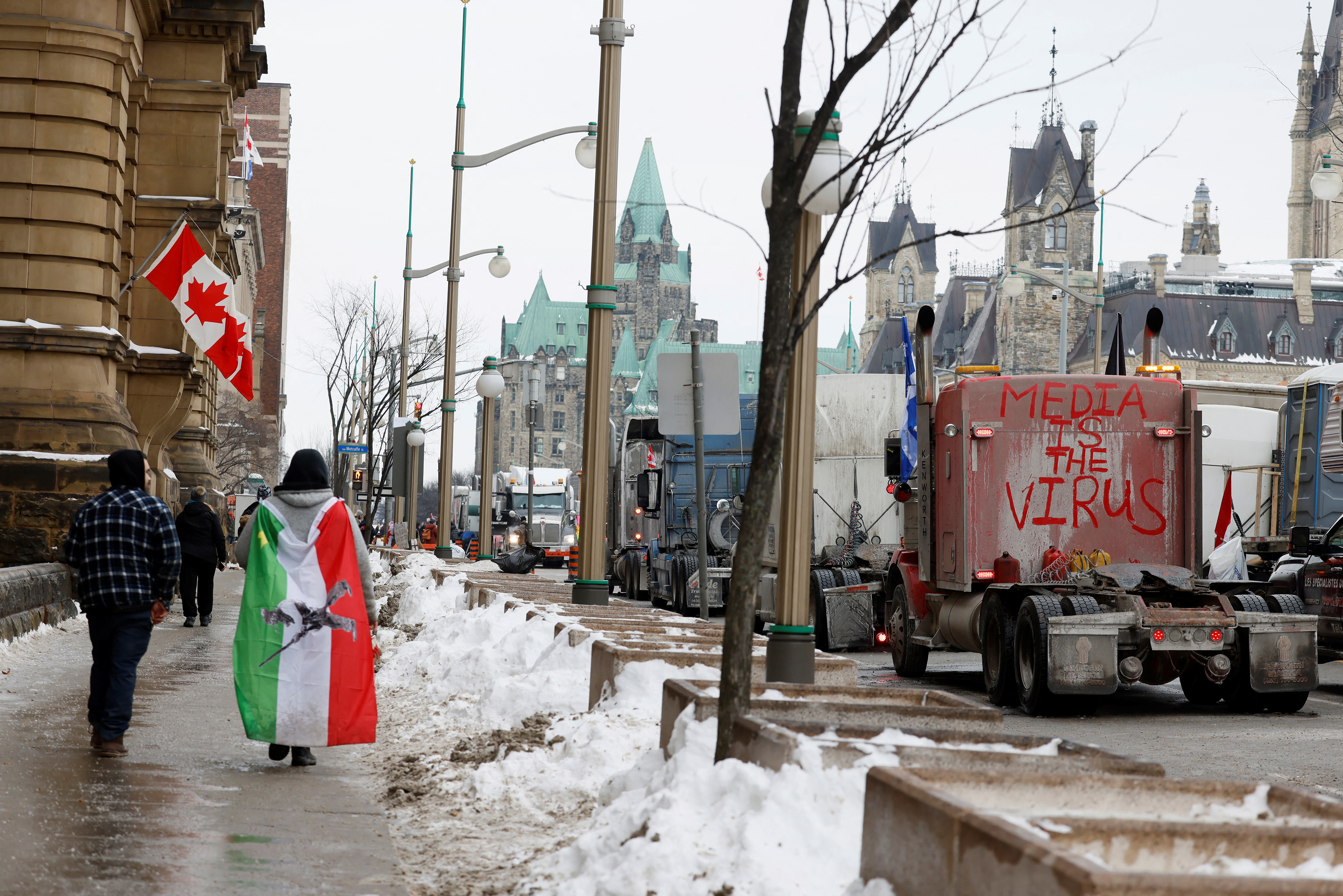 Protestors walk along the blockade beside Parliament Hill as protests against COVID-19 vaccine mandates continue in Ottawa