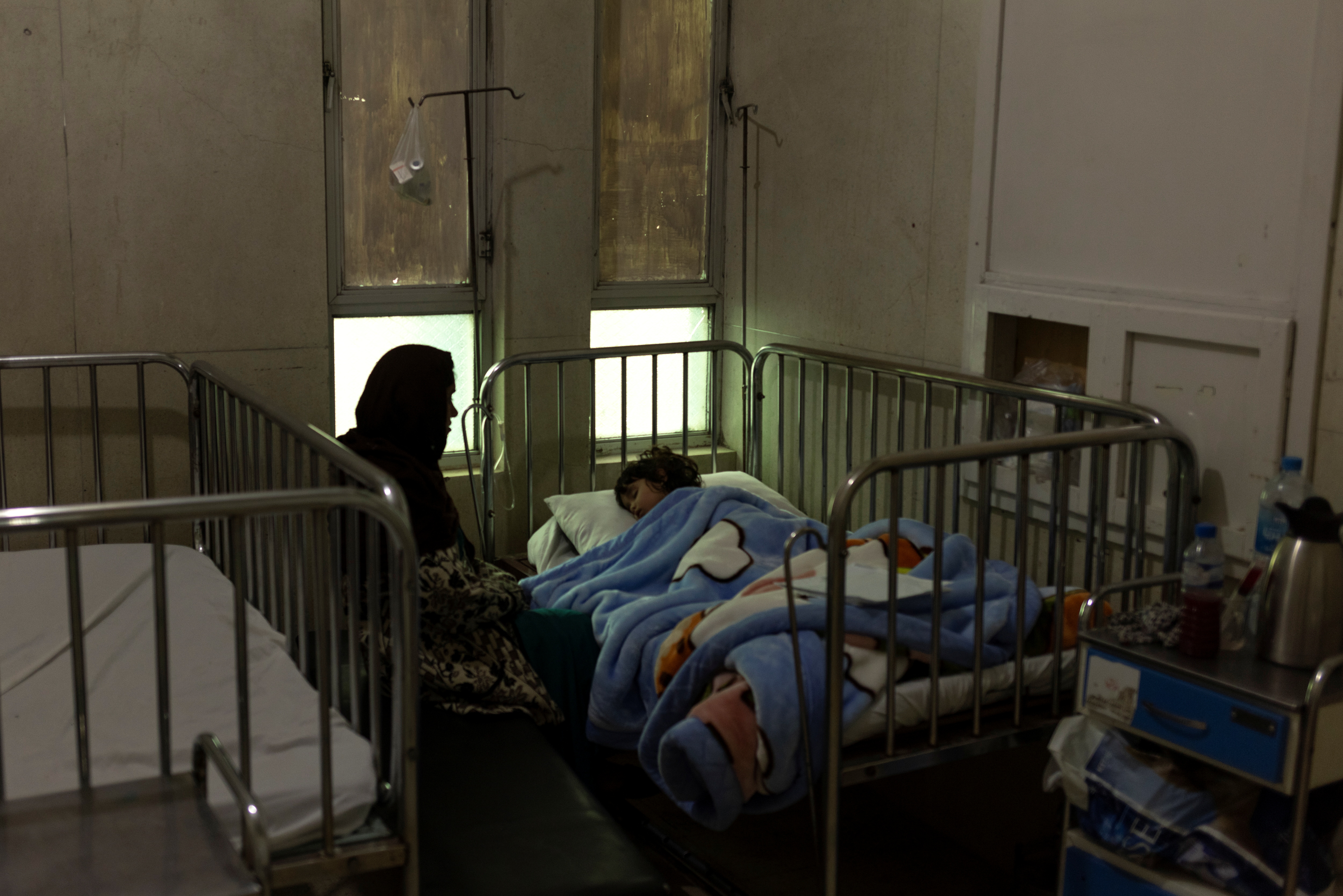A family is seen at the intensive care unit at the Indira Gandhi hospital in Kabul