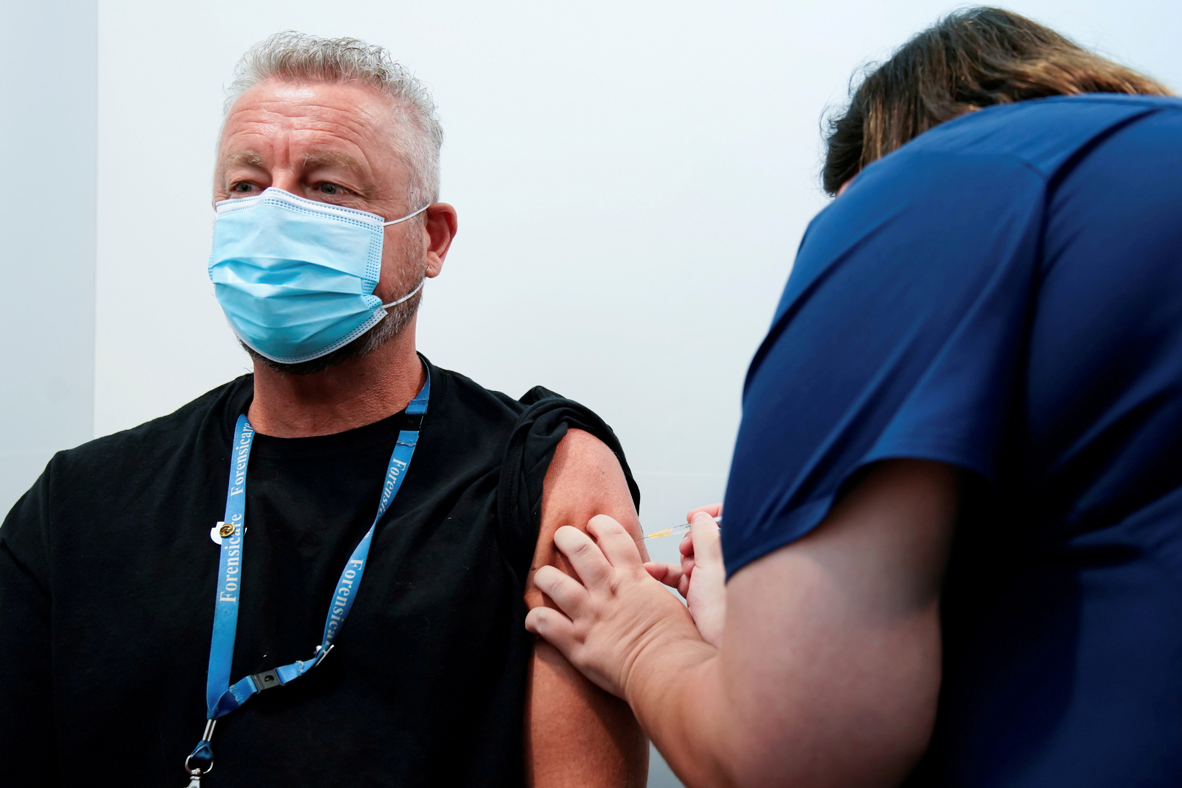 The Pfizer COVID-19 vaccine is administered to a high-risk worker in Melbourne